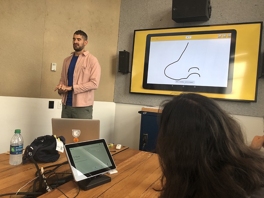 a course class with students and the teacher presenting the design lesson
