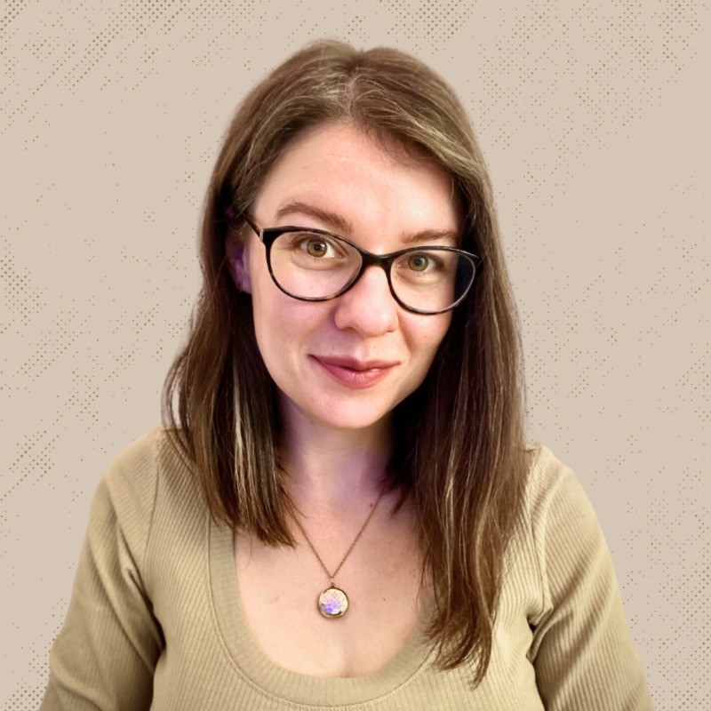 Profile portrait of a man in a white shirt against a light background