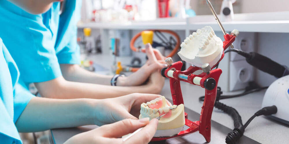 Lab assistant working in dental laboratory