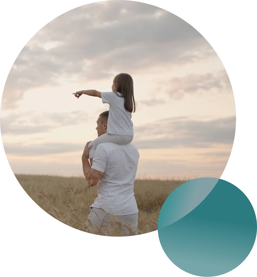 Couple cooking together in a bright kitchen while smiling at each other.