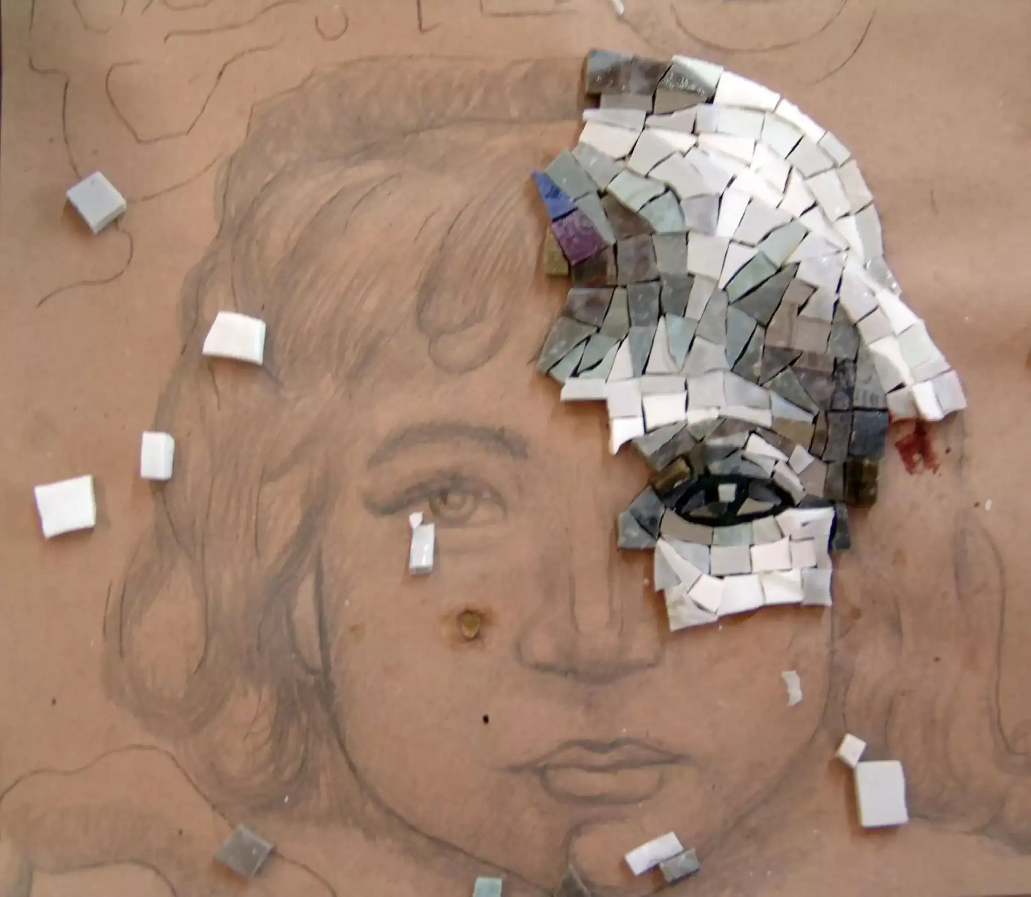 Mosaic glass tile portrait of a woman's face with small mosaic pieces and smalti.