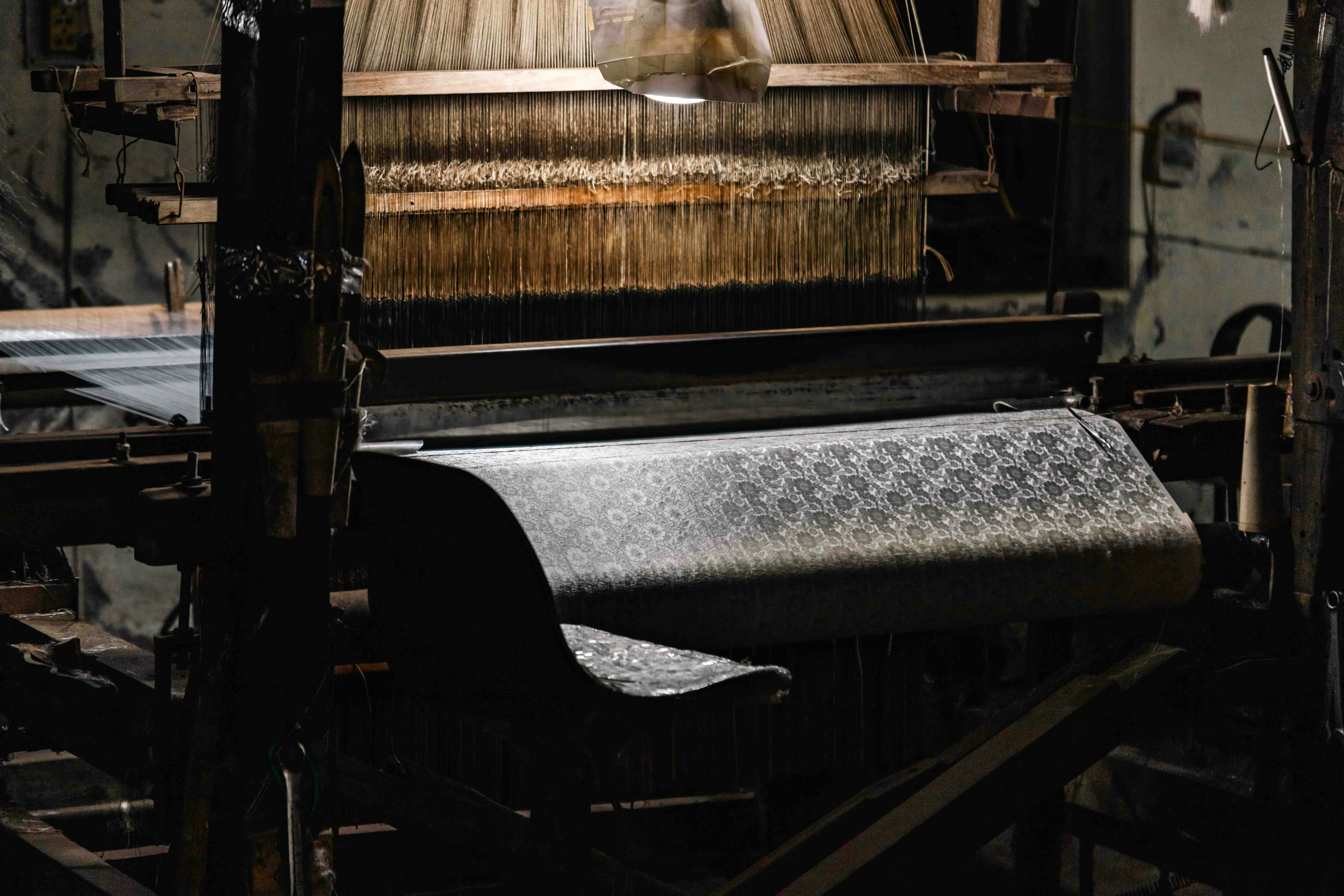 A vintage loom with intricate patterned fabric