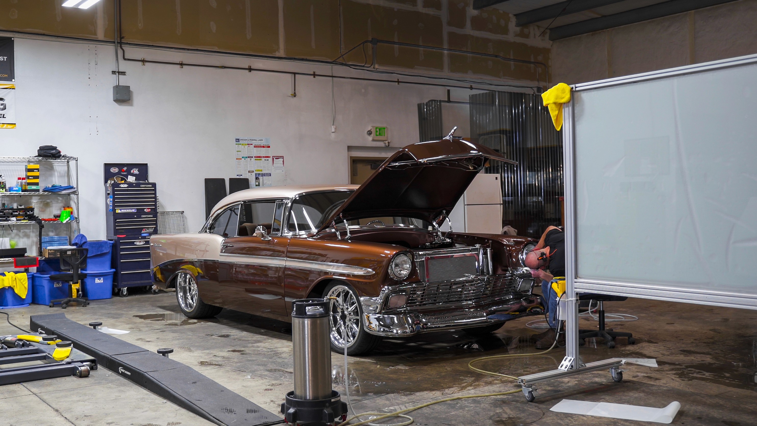 A team of professionals collaborates around a table, discussing documents in a focused and dynamic setting.