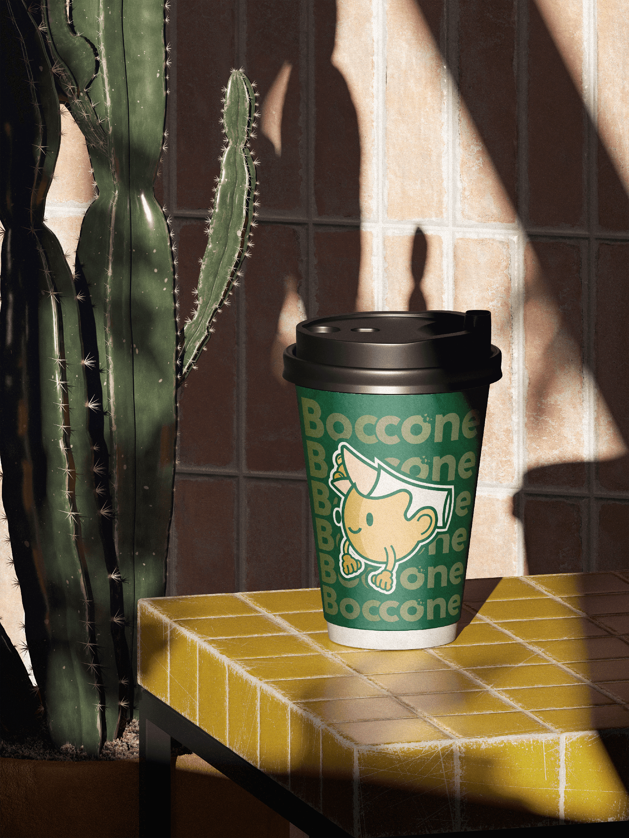 Boccone Café branded takeaway cup with mascot artwork placed on a yellow-tiled table beside a cactus, lit by warm sunlight and shadows.