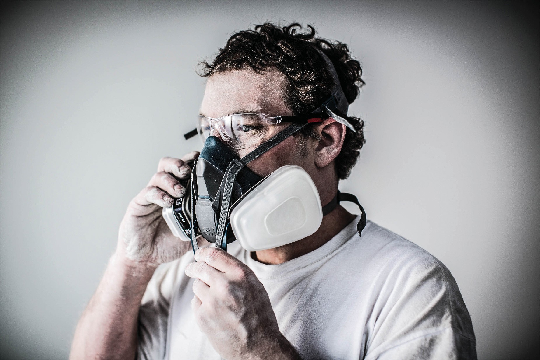 a man puts on respiratory protection