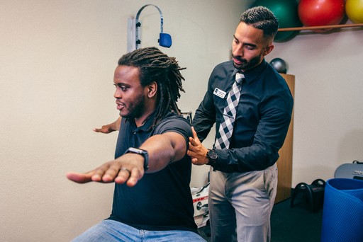 chiropractor dr hochstein helping patient with range of motion exercises