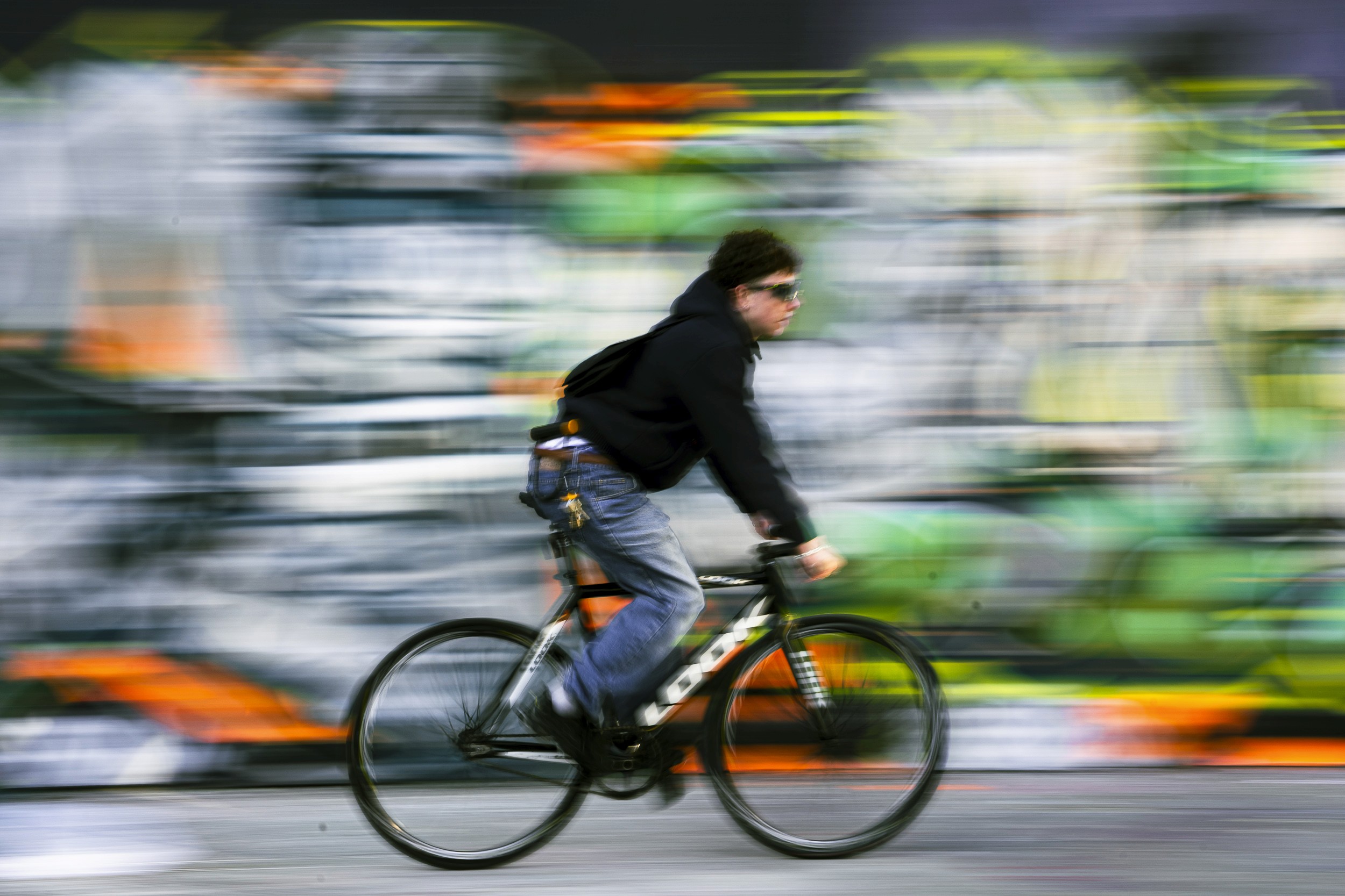 A fast black sports car races down the highway.
