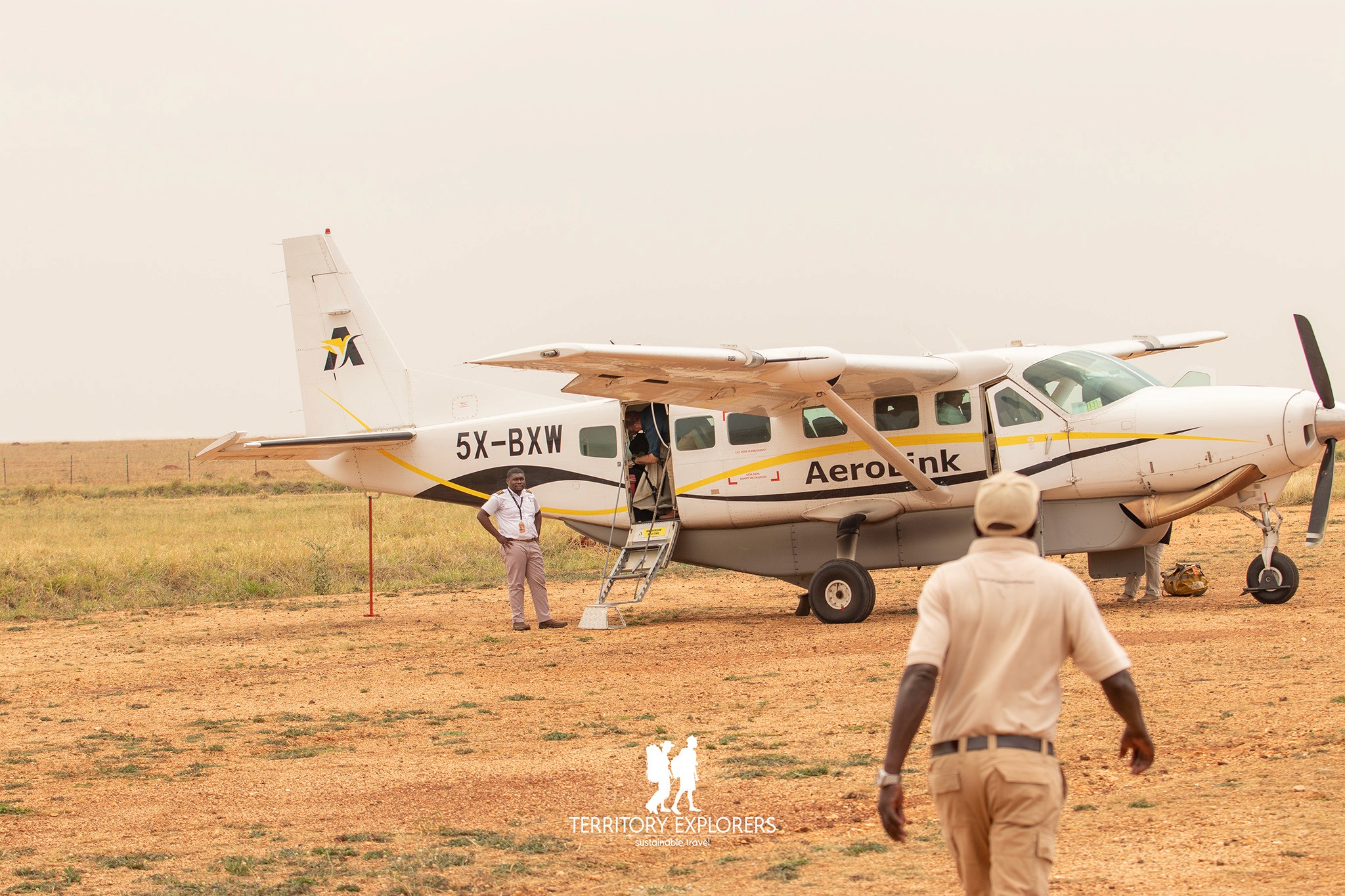 Tourist arriving in Kidepo Valley National Park aboard an aerolink cessna plane