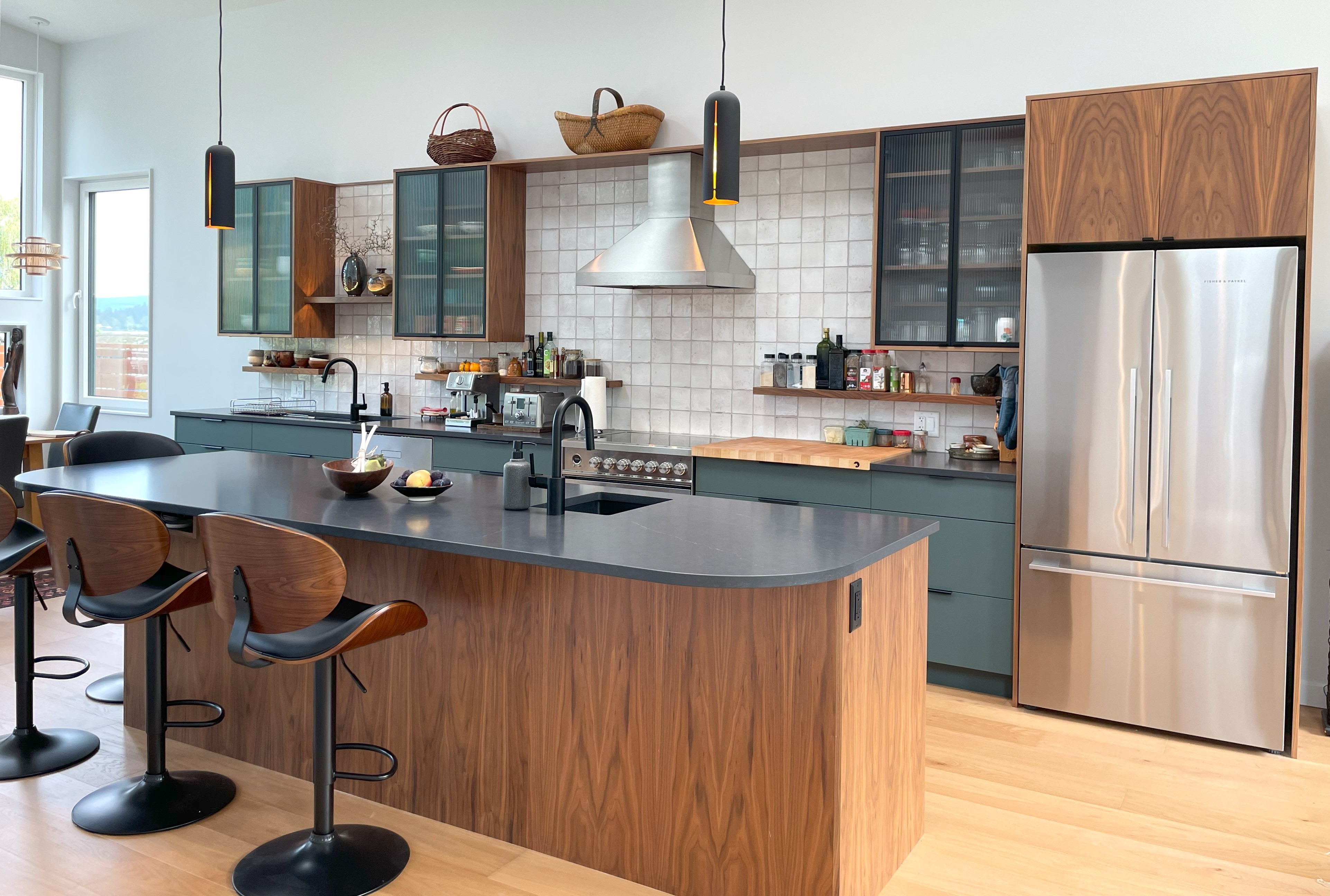 Spacious, luxurious living room with high ceilings, an elegant beige sectional sofa, warm ambient lighting, classical artwork, and rustic architectural elements, featuring an open layout with a view of a mezzanine level.