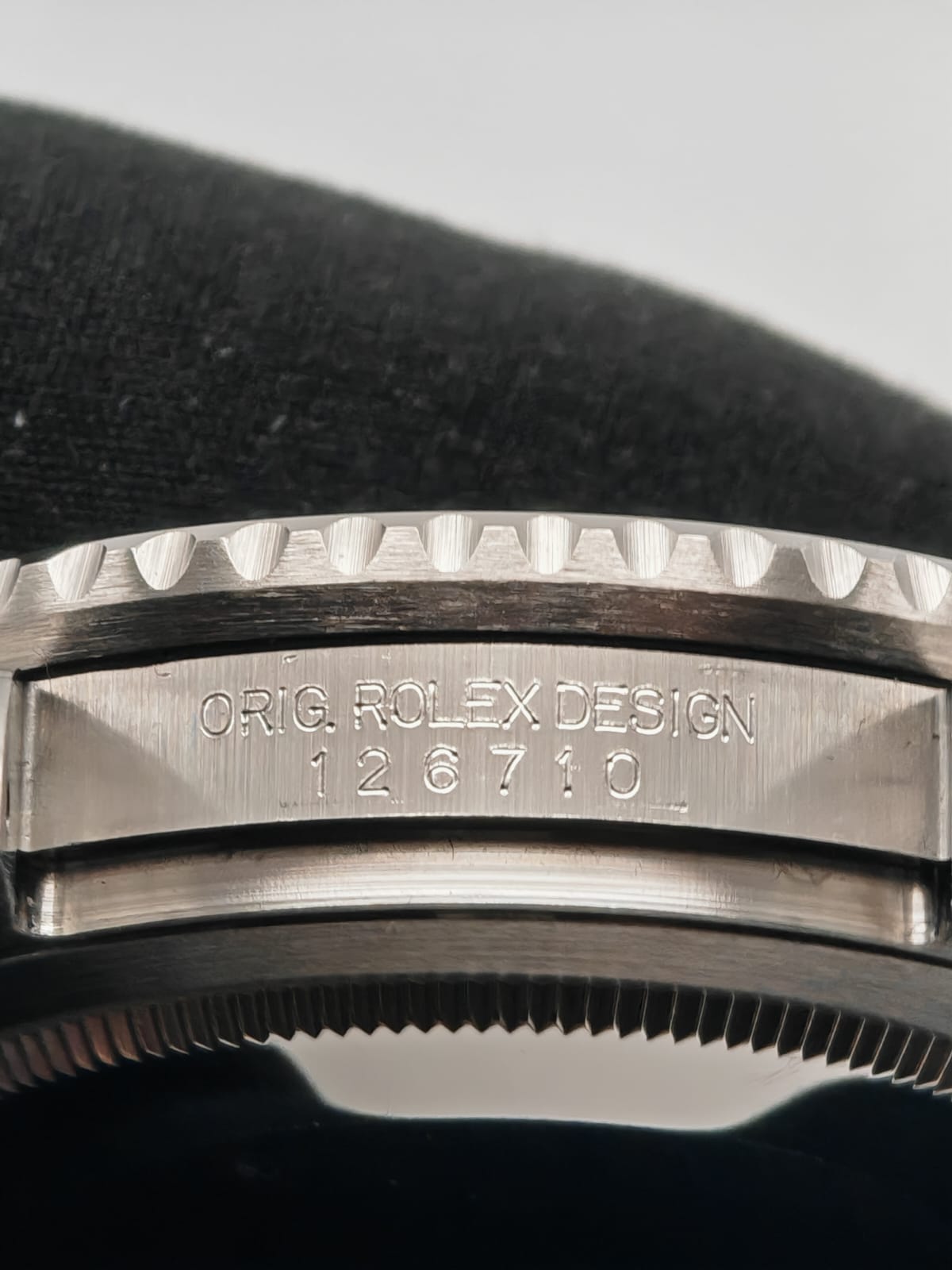 a close up of a watch on a black surface
