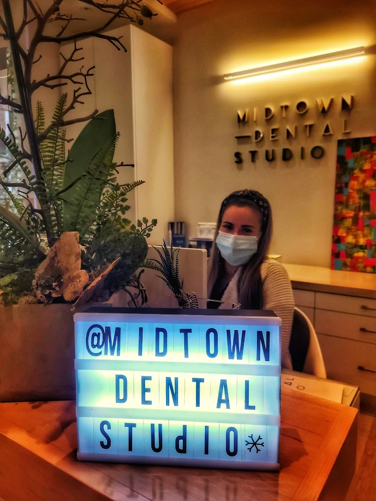 Dental receptionist helping a patient with dental insurance at Midtown Dental Studio on Eglinton in Midtown Toronto, Ontario | Best Dentist in Midtown Toronto, Ontario