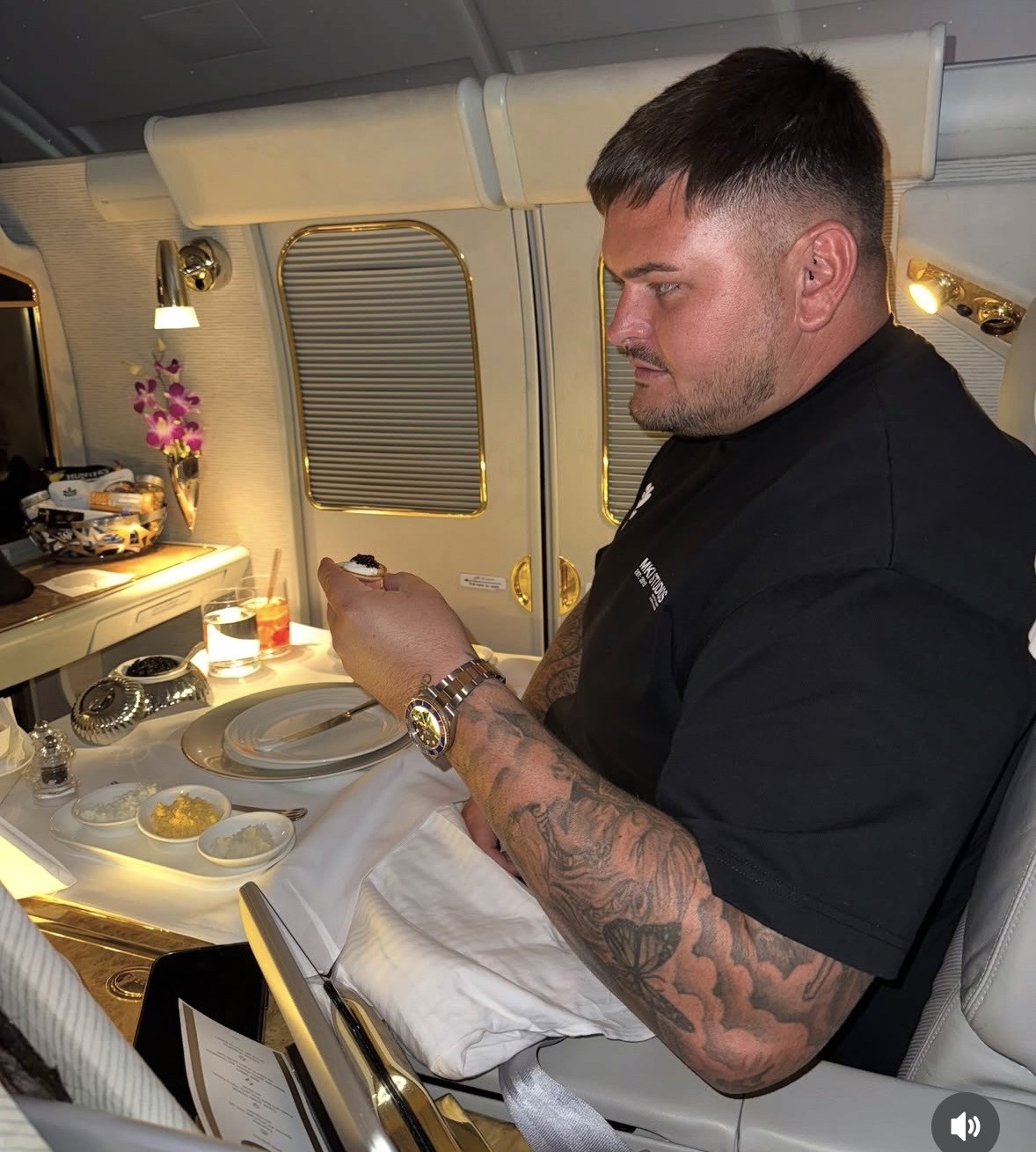 Photo of Deri Morgan, founder of Evo X Academy, seated on a private jet with a meal in front of him