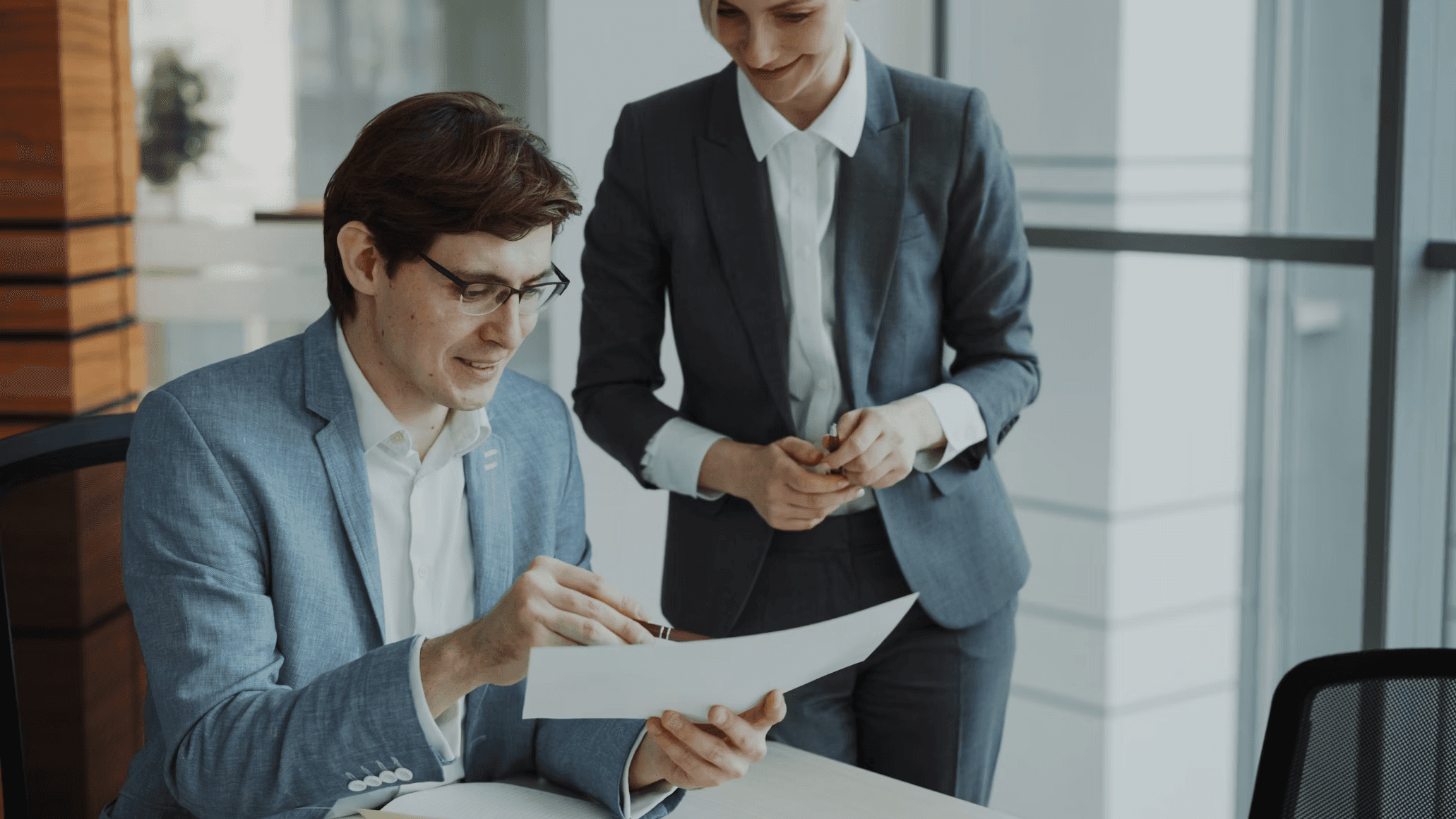Two people discussing a paper conract