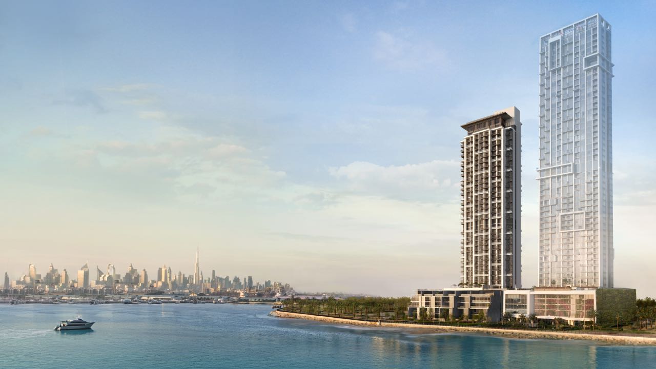 A construction site for Anwa Aria by Omniyat, featuring a tower being built in the middle of the water.