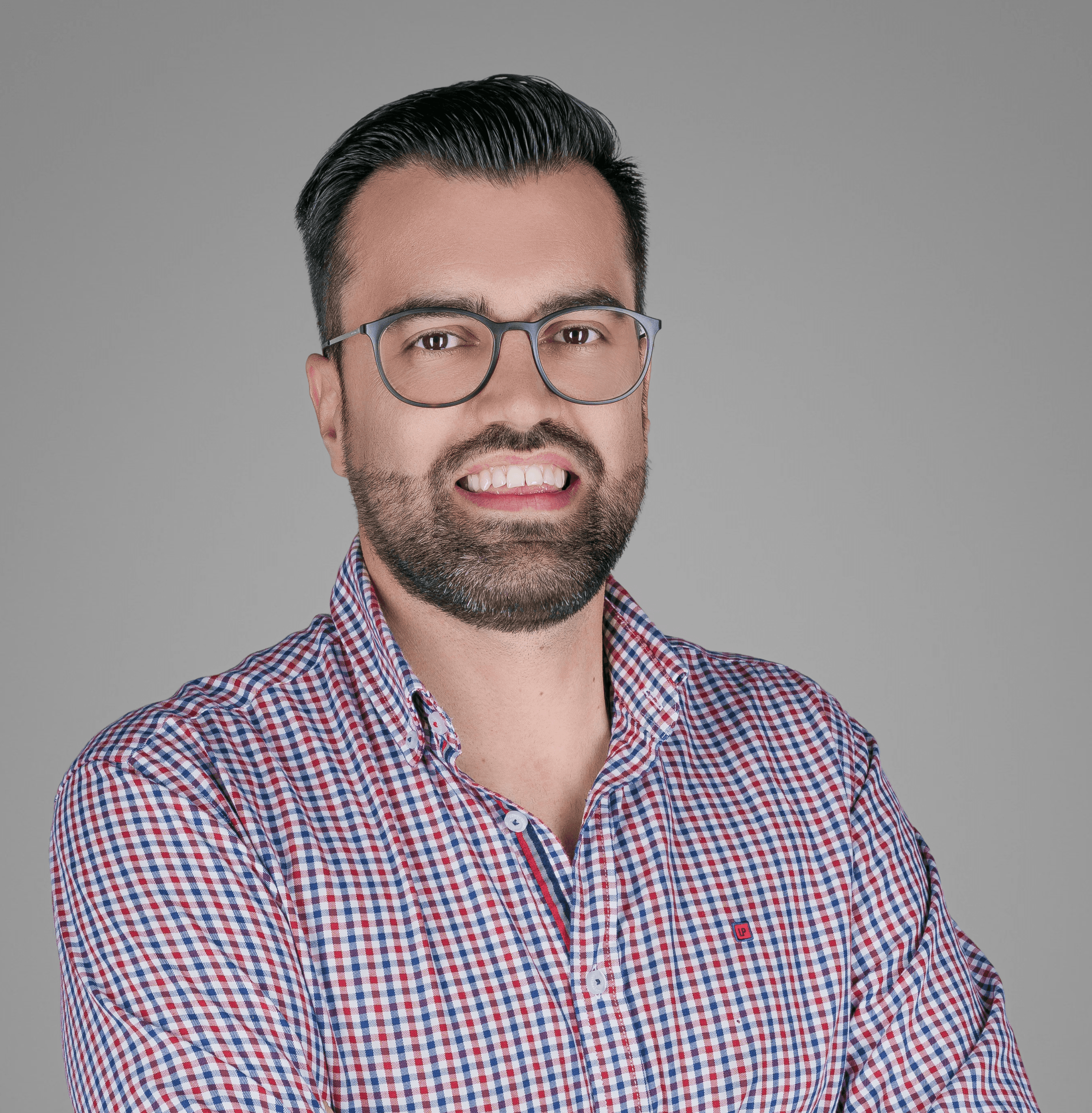 A minimalist wooden desk with a small lamp and an open notebook, situated in a bright, warm-lit room.