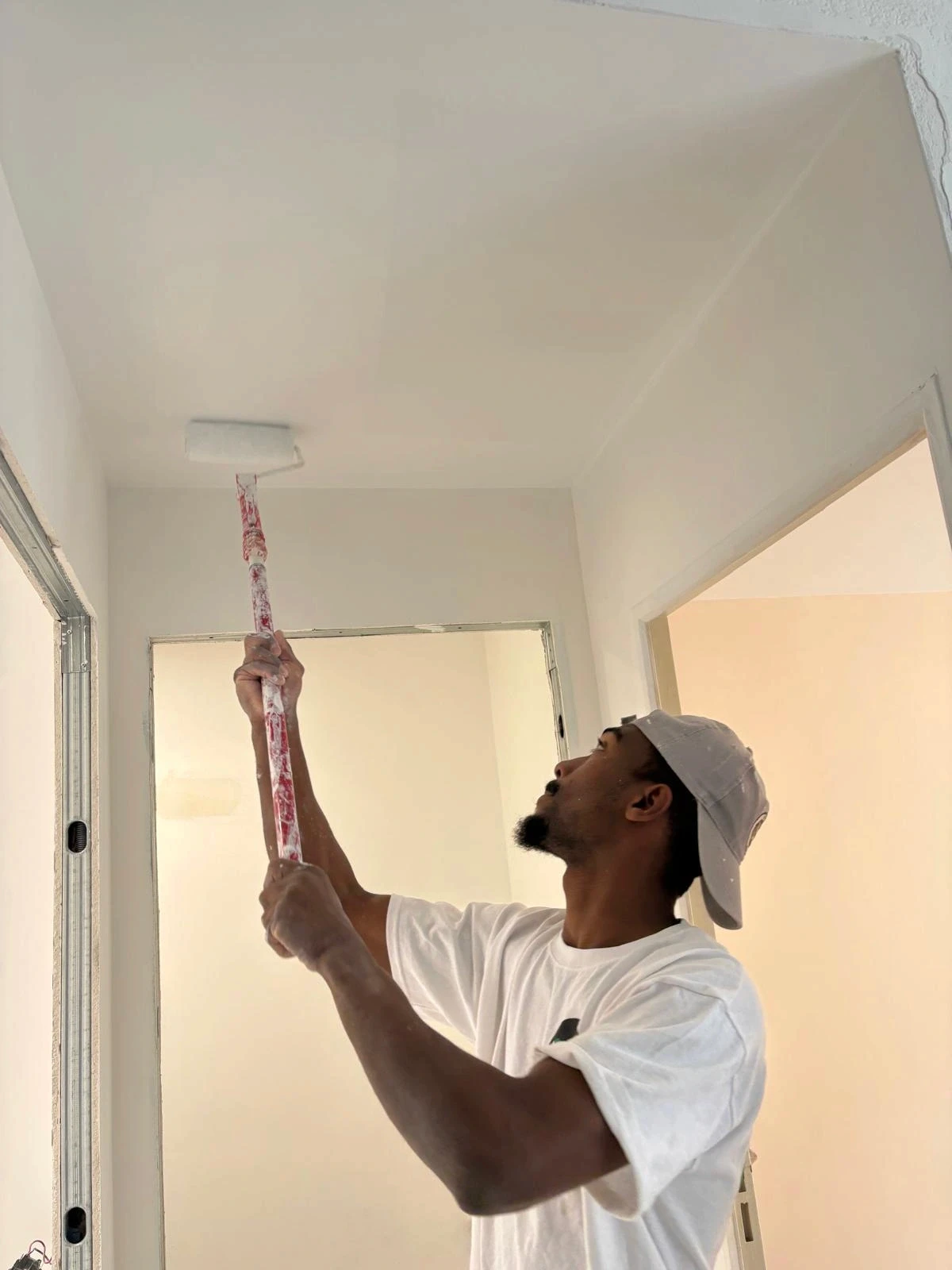 Nelson peignant le plafond d'un appartement à Valbonne