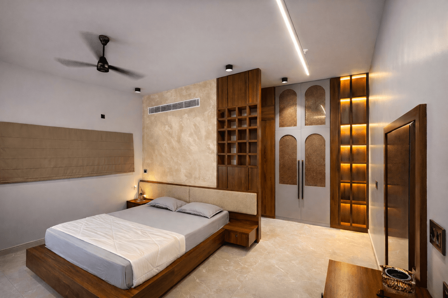 Modern two-story home with large glass windows, warmly lit interiors, and a balcony. Surrounded by trees and a manicured lawn at dusk. Cozy ambiance.