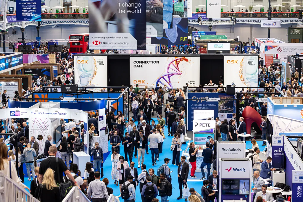 A bustling convention floor at London Tech Week, filled with attendees exploring various tech company booths, interactive displays, and networking areas.