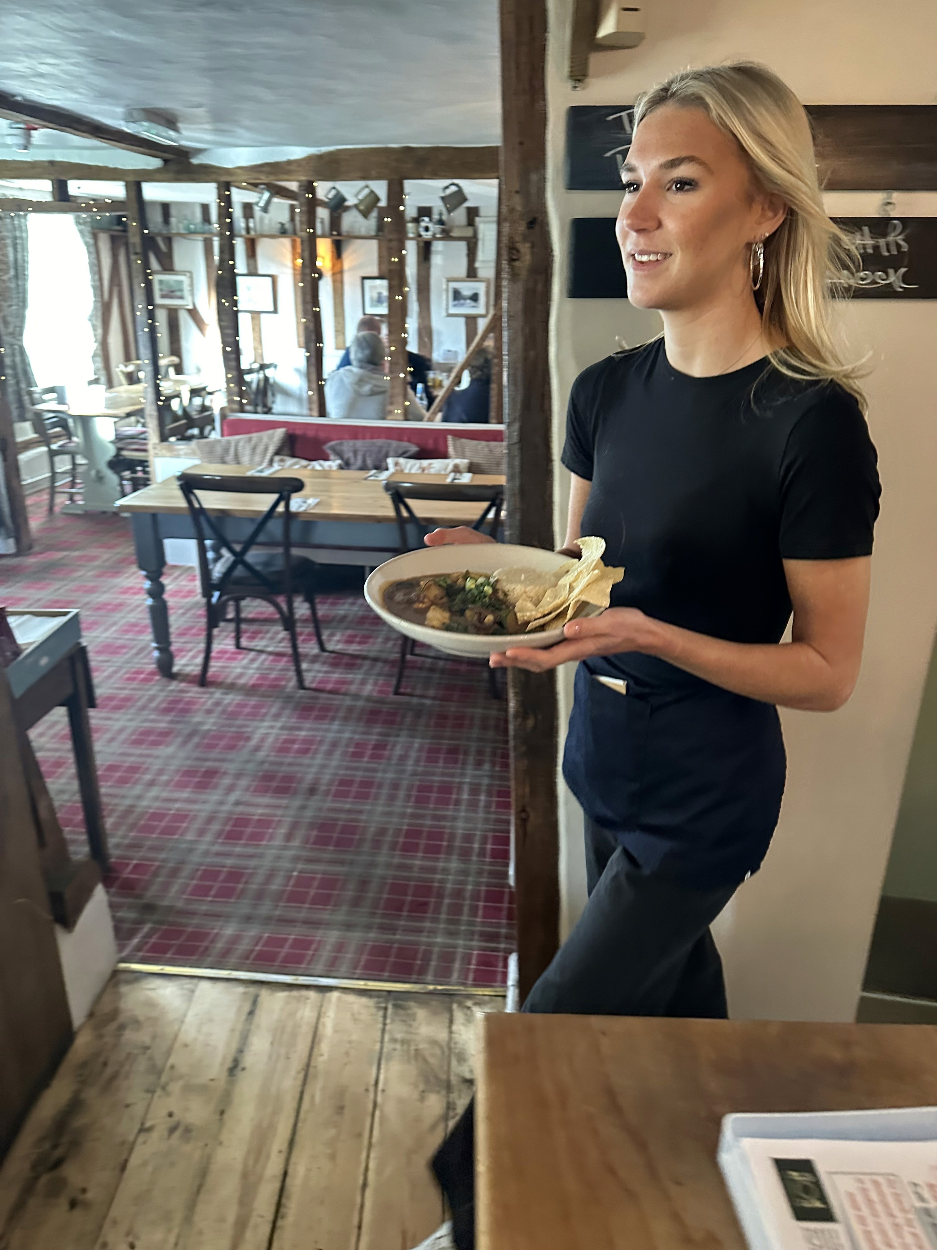 Waitress serving food in The Norton Dog