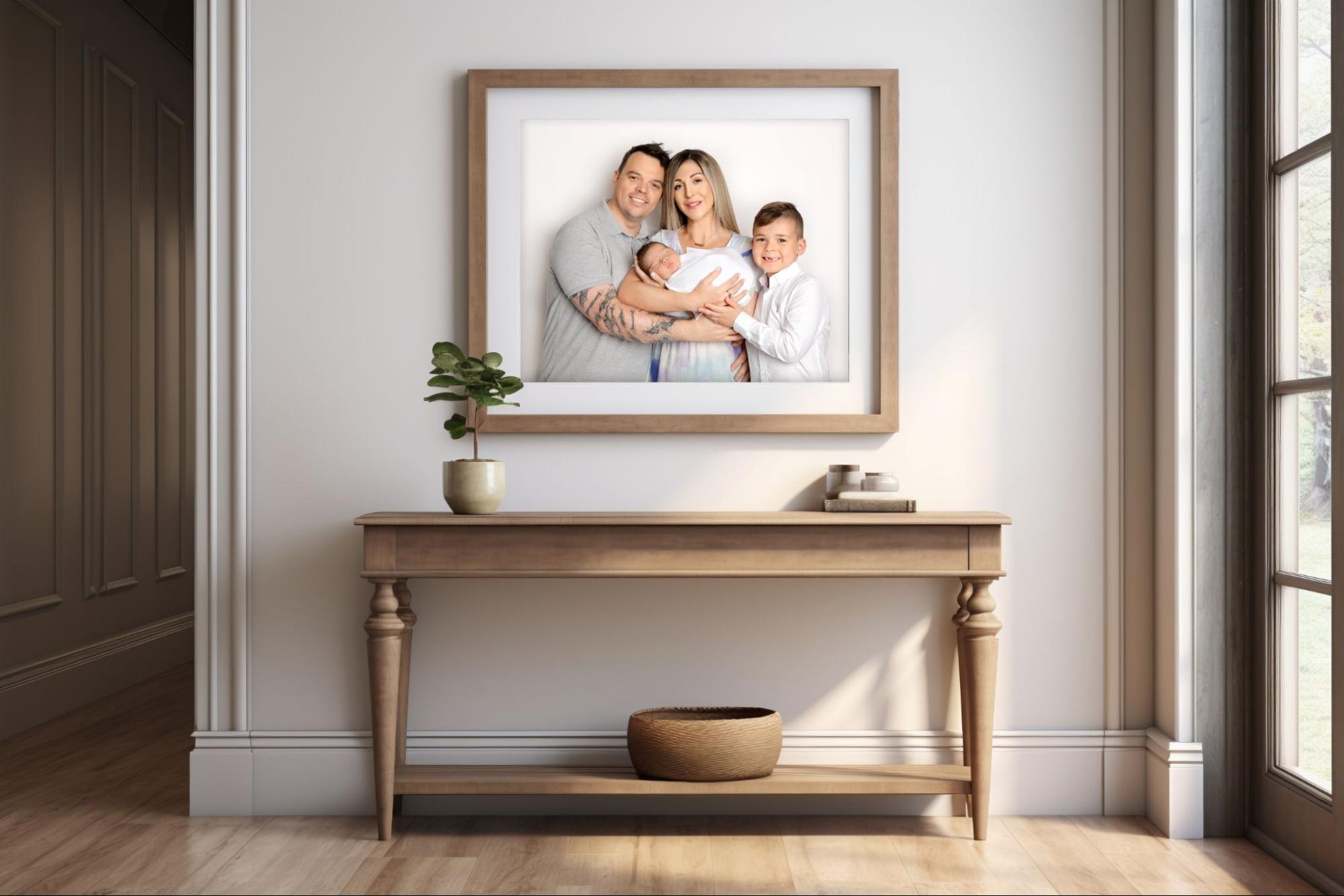 Minimalist family portrait by Mahvin Photography on a beige wall, featuring elegant and modern photo wall ideas for homes.