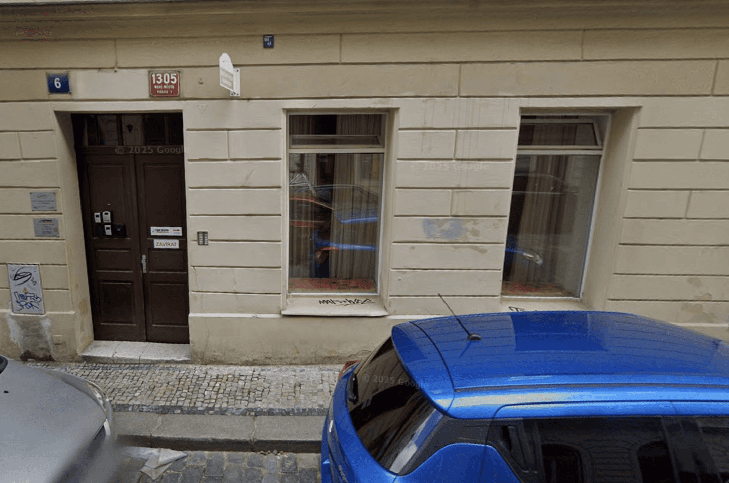 Night view of a luxurious modern corner retail building with rounded architecture, warm ambient lighting, tall glass walls, and minimal interior displays under a dark sky.