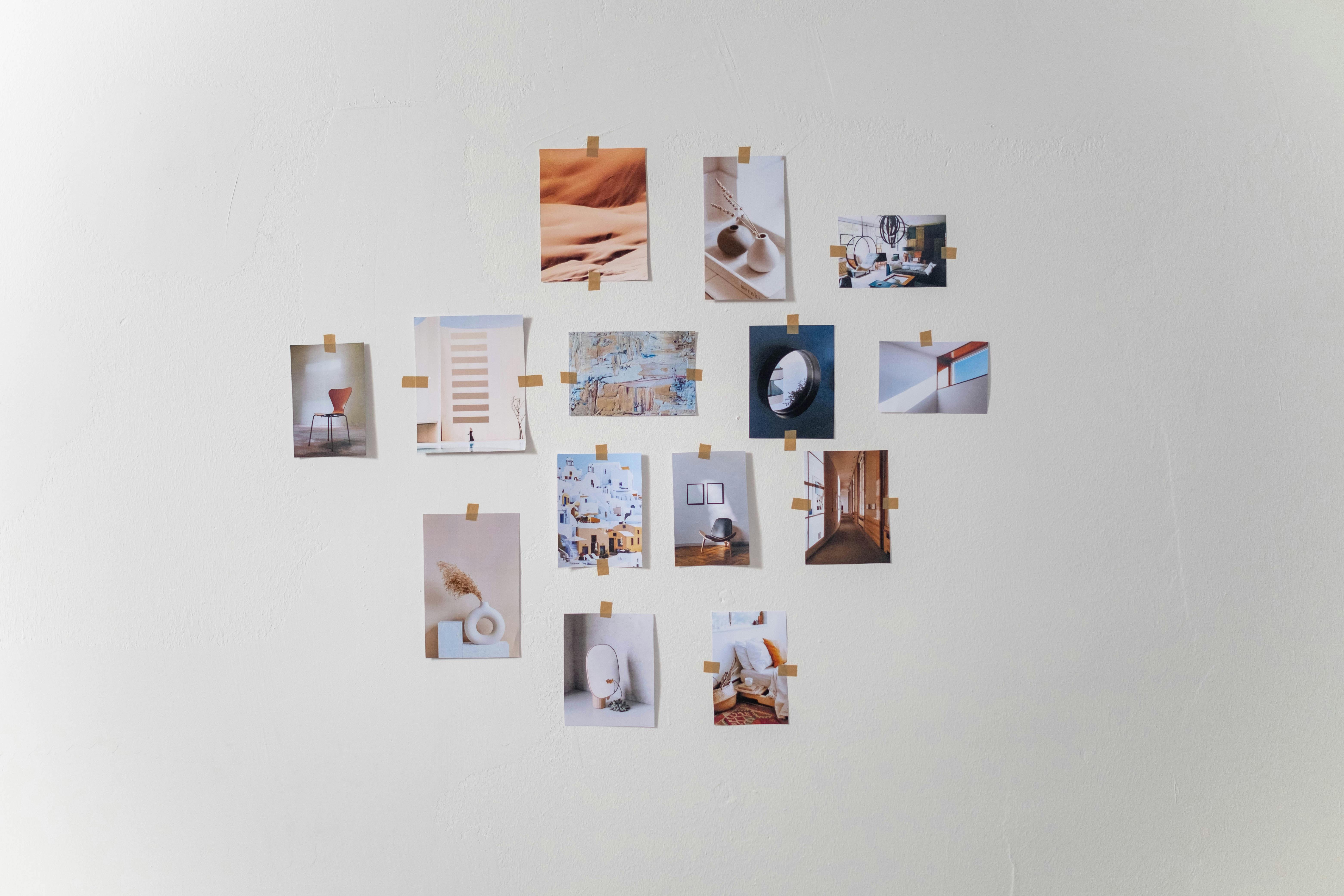 Collection of printed photos arranged on wall, representing visual asset organization and selection