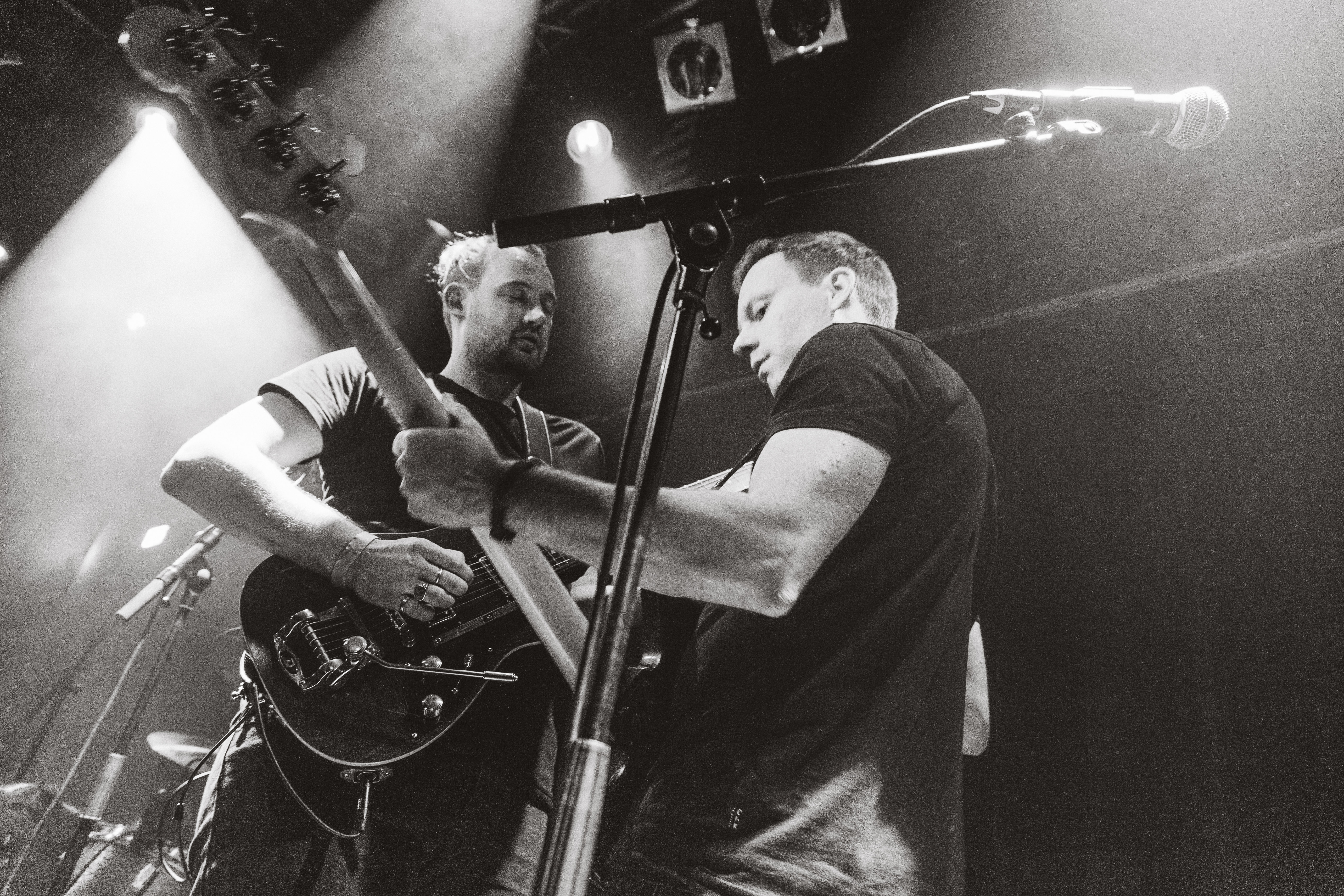 Man wearing sunglasses and headscarf in low light
