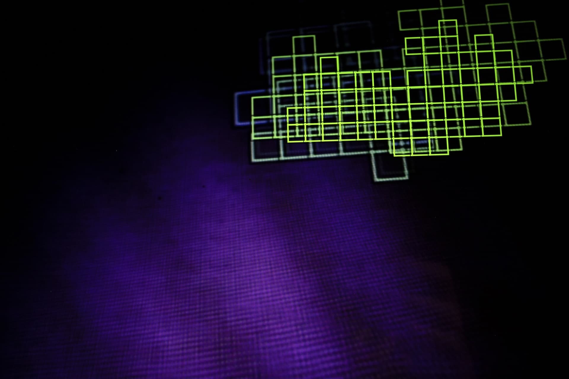 Dense concentration of green autofocus boxes layered against purple screen glow, overlapping grid pattern showing camera's computational vision searching for focus