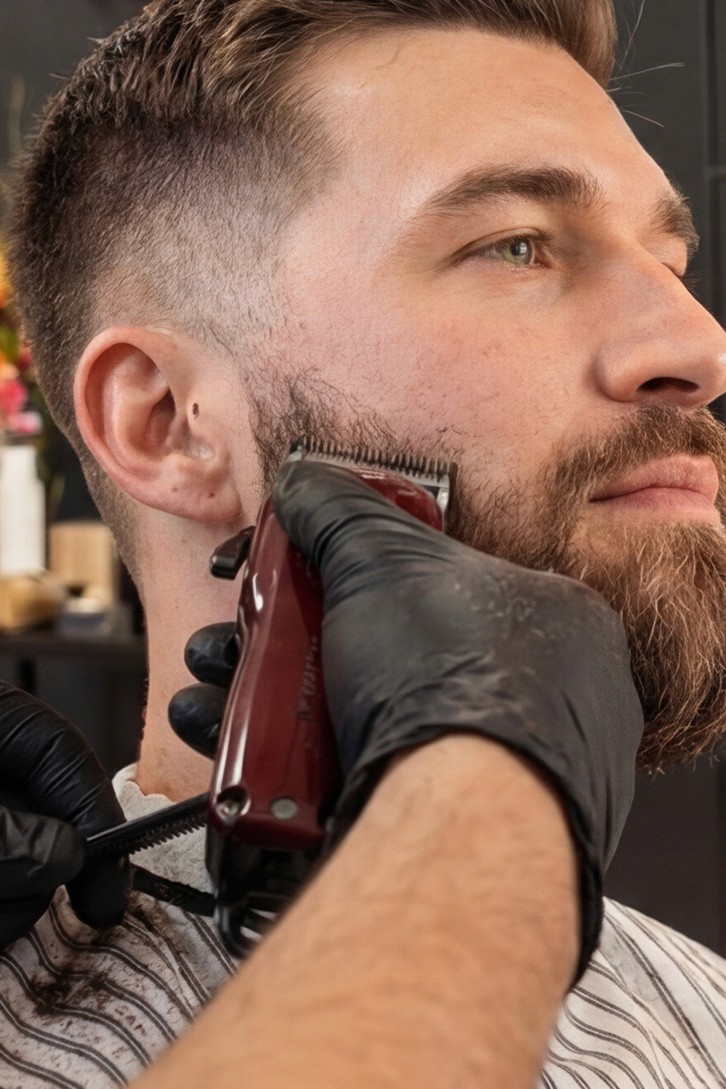 Beard being trimmed with electric clippers