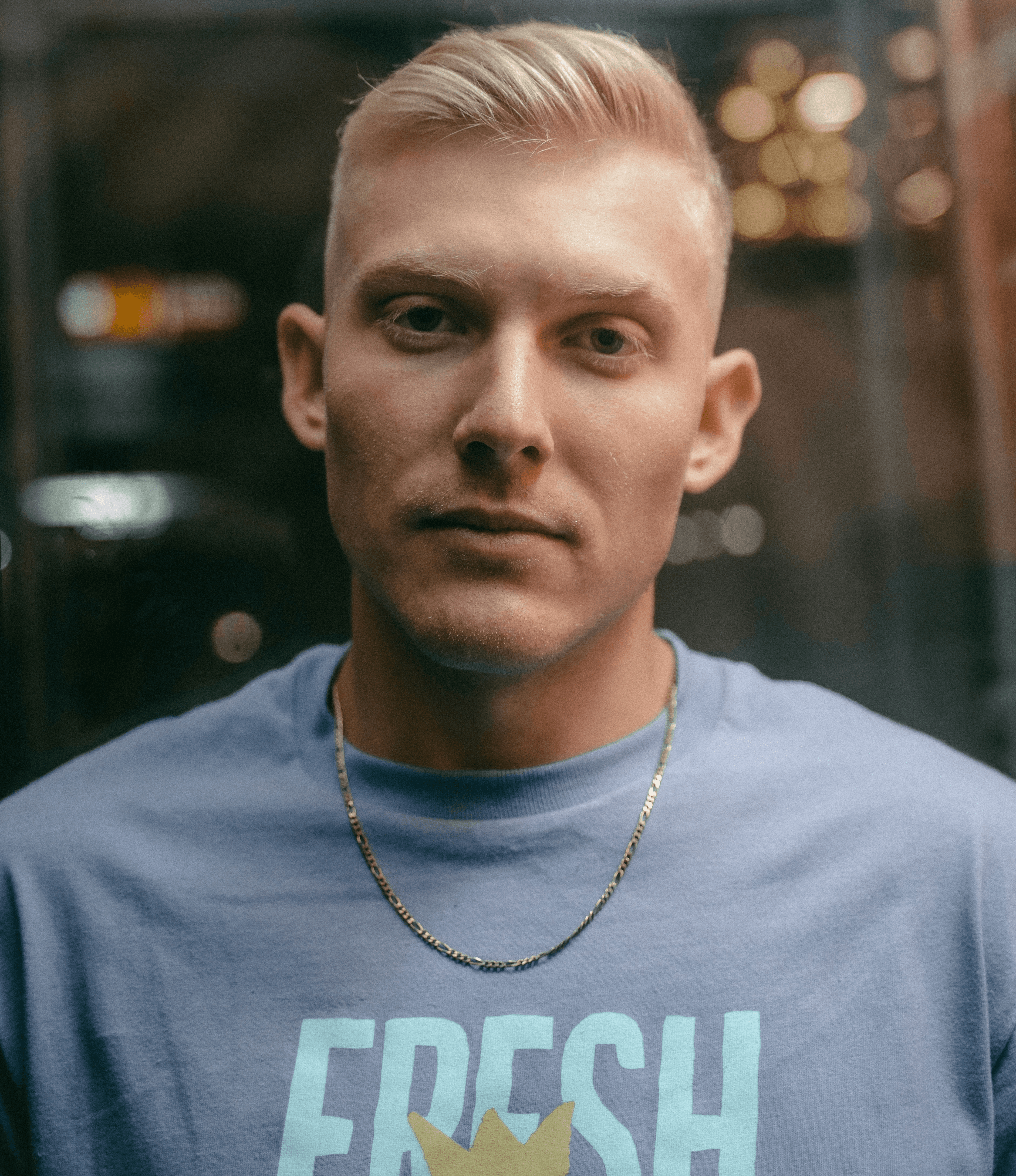 man in white crew neck shirt wearing silver necklace