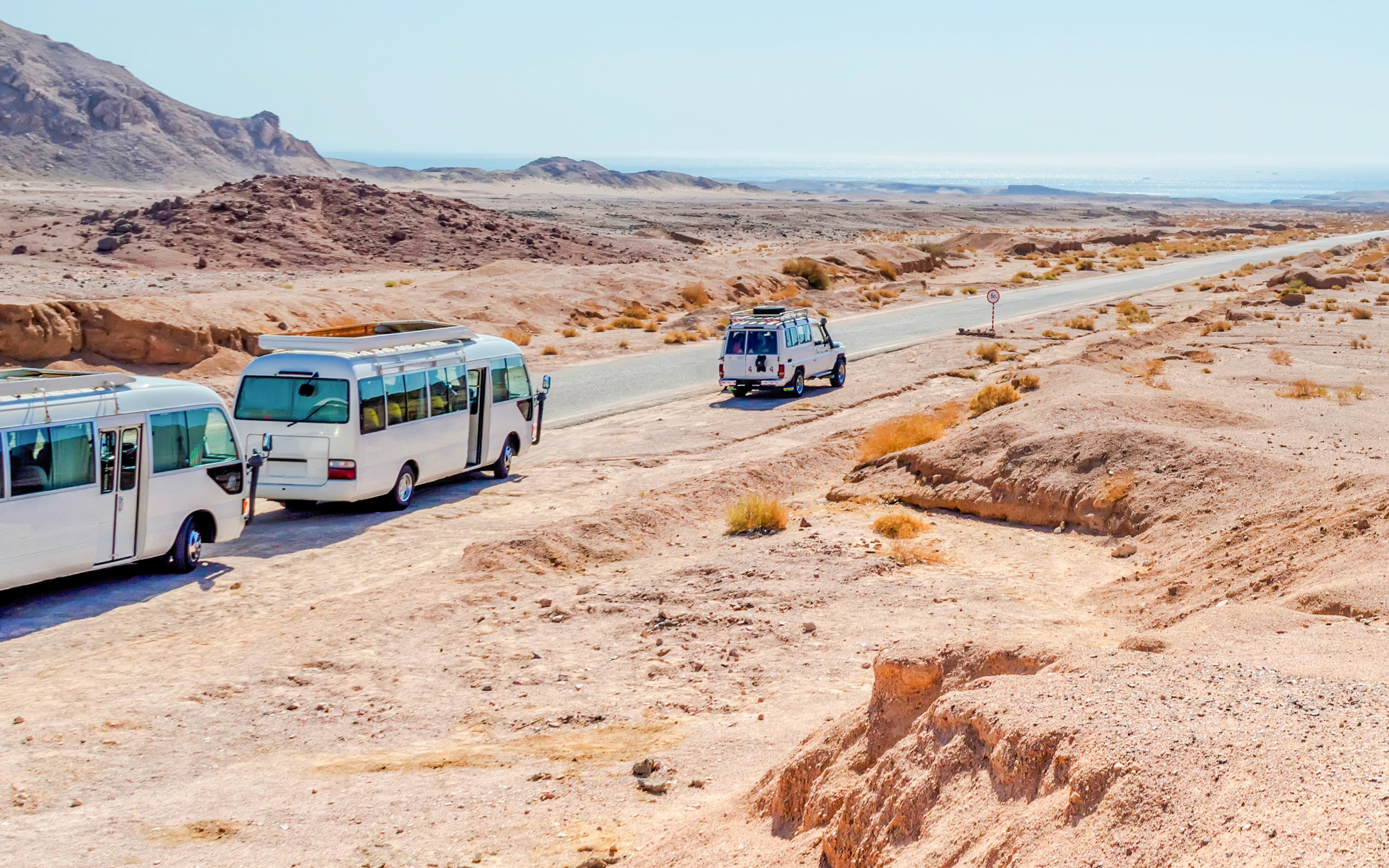 Minibuses parked at Ras Mohamed National Park, Sharm El Sheikh desert landscape.