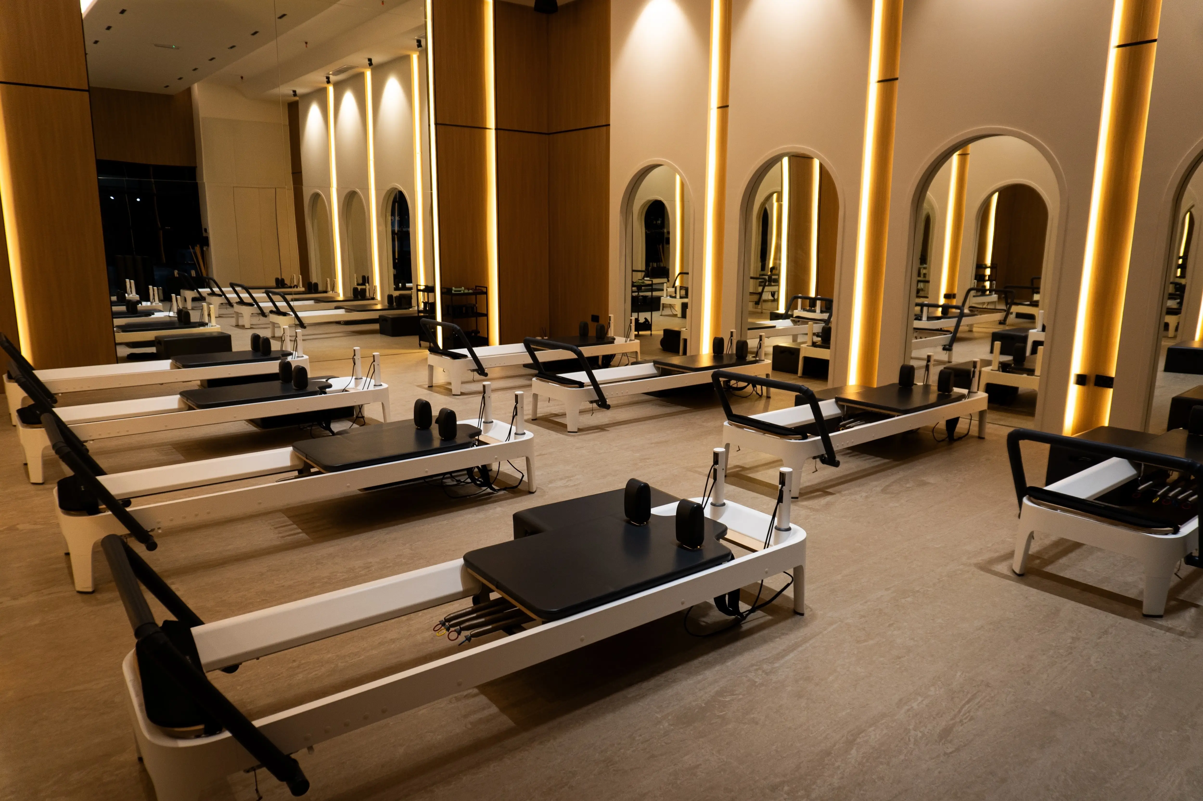Weight training area with benches and dumbbell racks inside The Alpha Club.