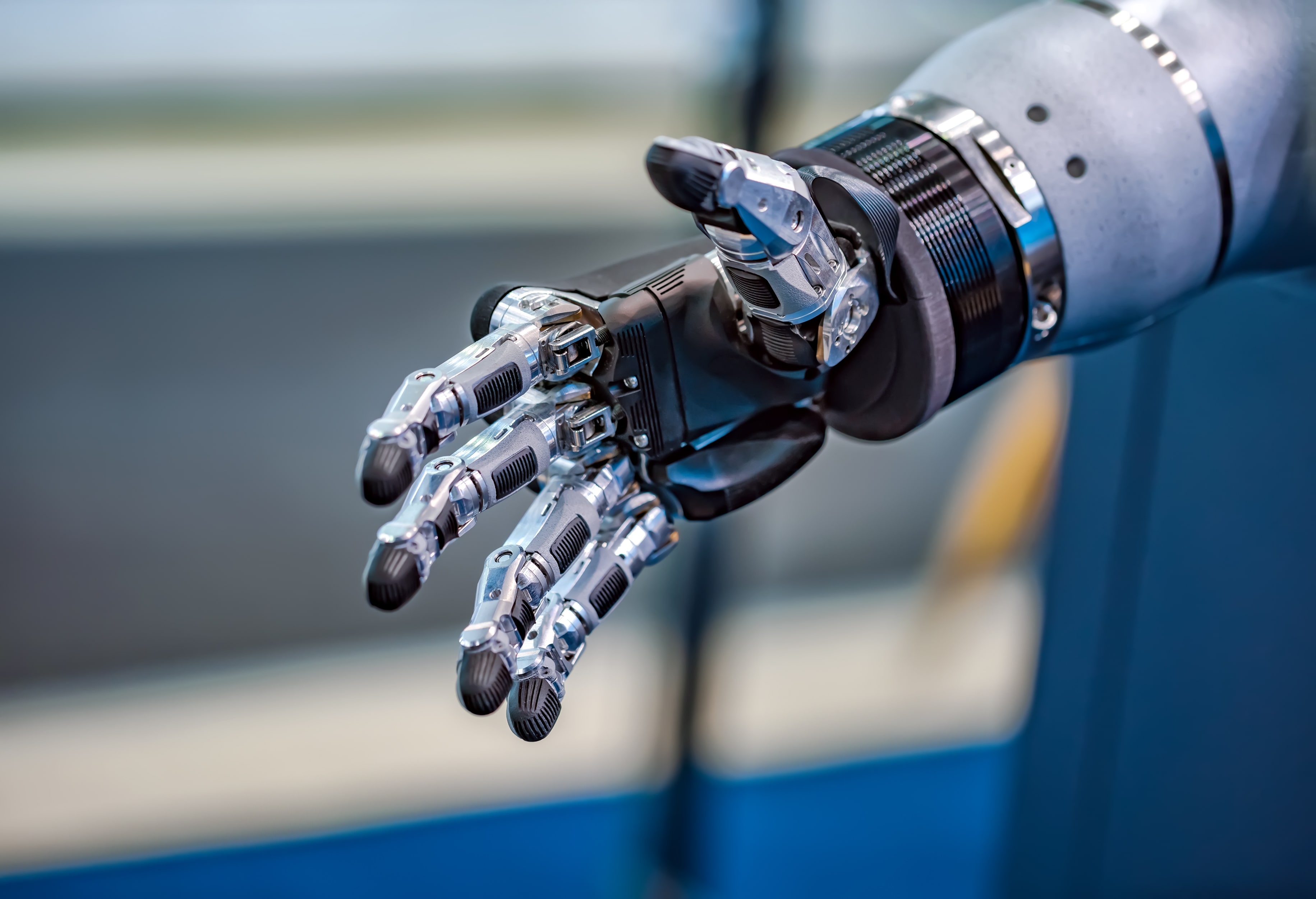 Close-up of a futuristic robotic hand extended for a handshake, showcasing advanced prosthetic or robotic technology in artificial intelligence and robotics.