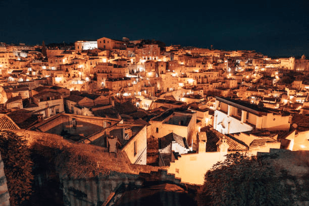Matera Sassi cave dwellings glowing at night in Italy