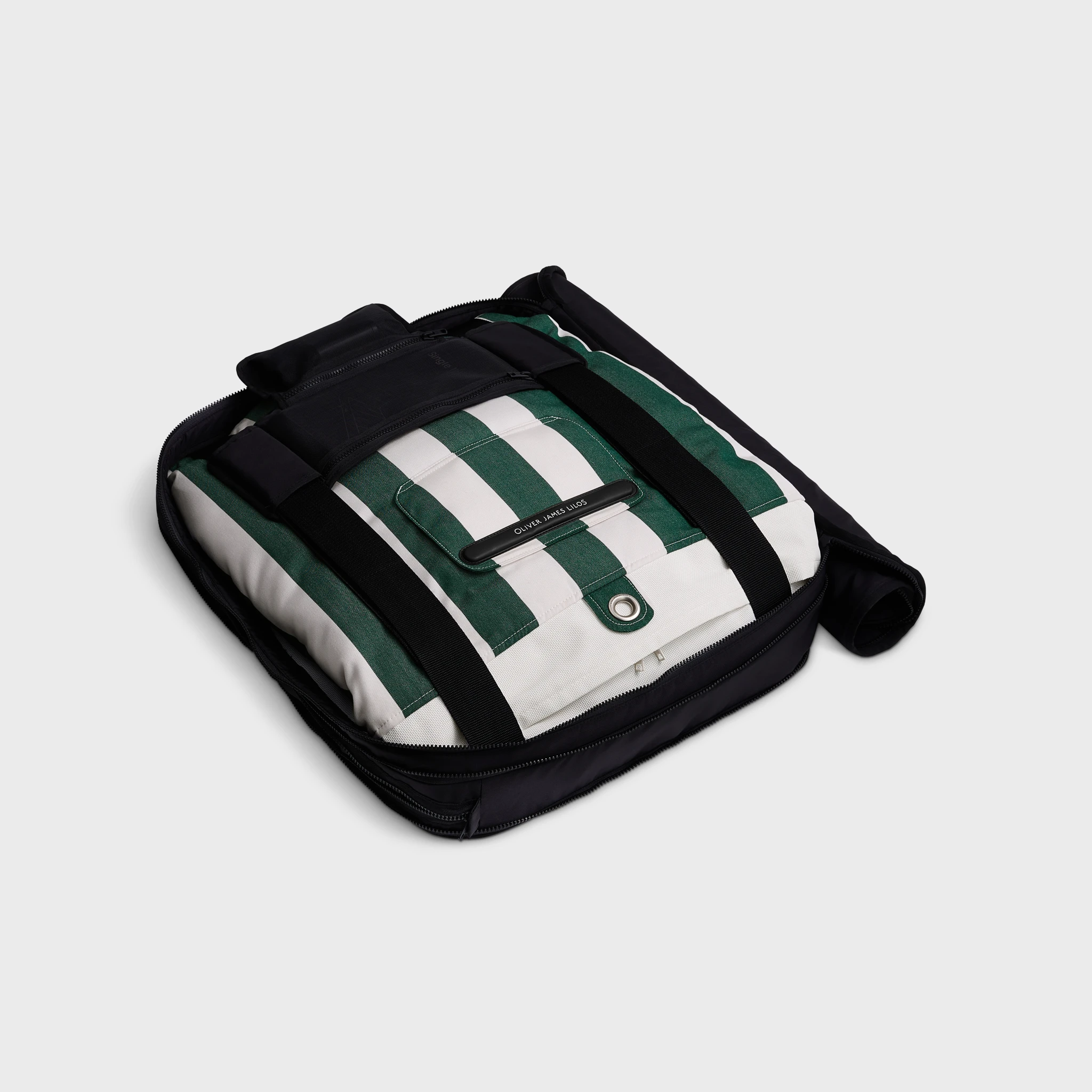 Oliver James lounger float folded in a sleek black carry case, with green and white striped fabric neatly secured for premium portability.