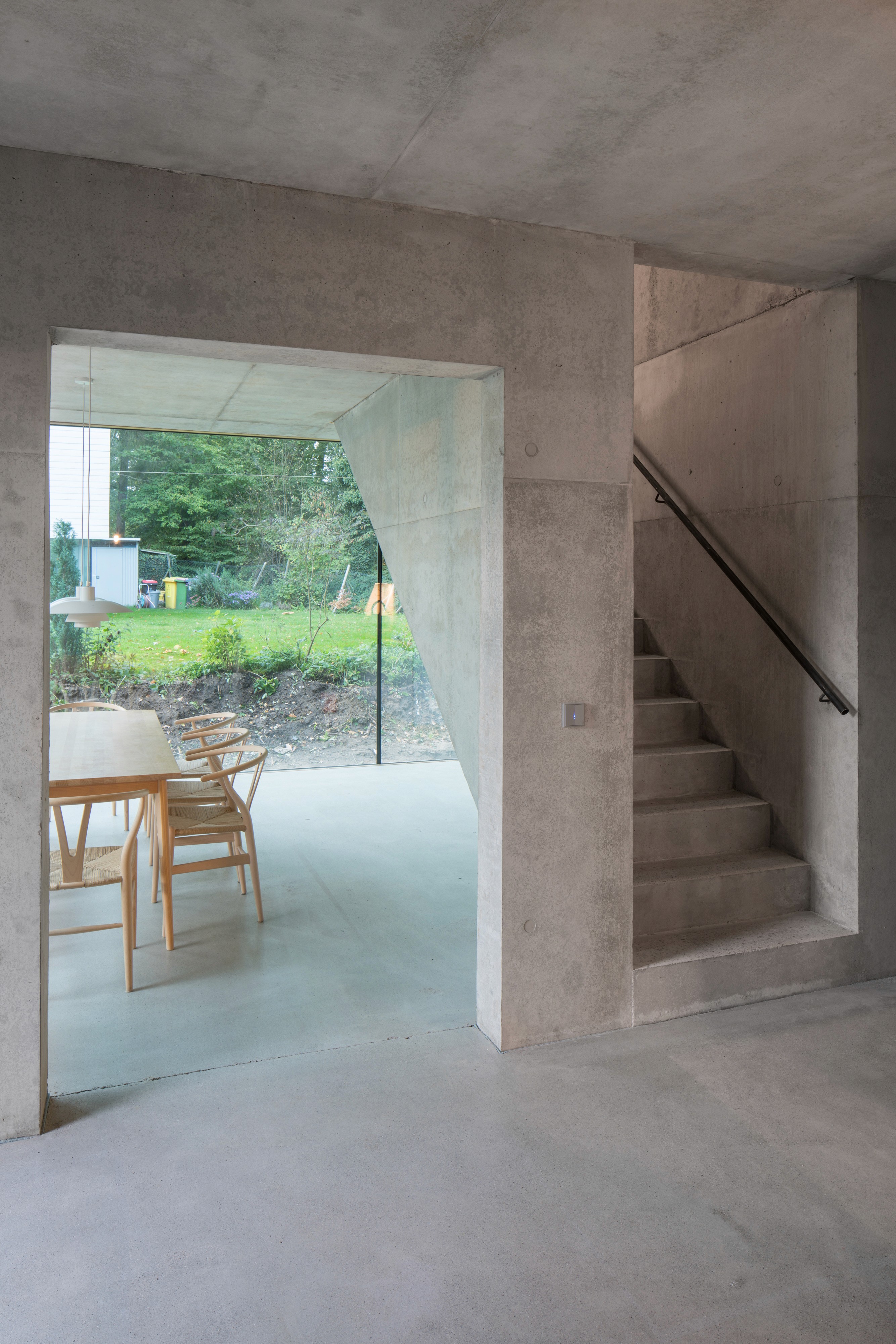 A large group photo of diverse team members gathered in an industrial-style space with arched ceiling.