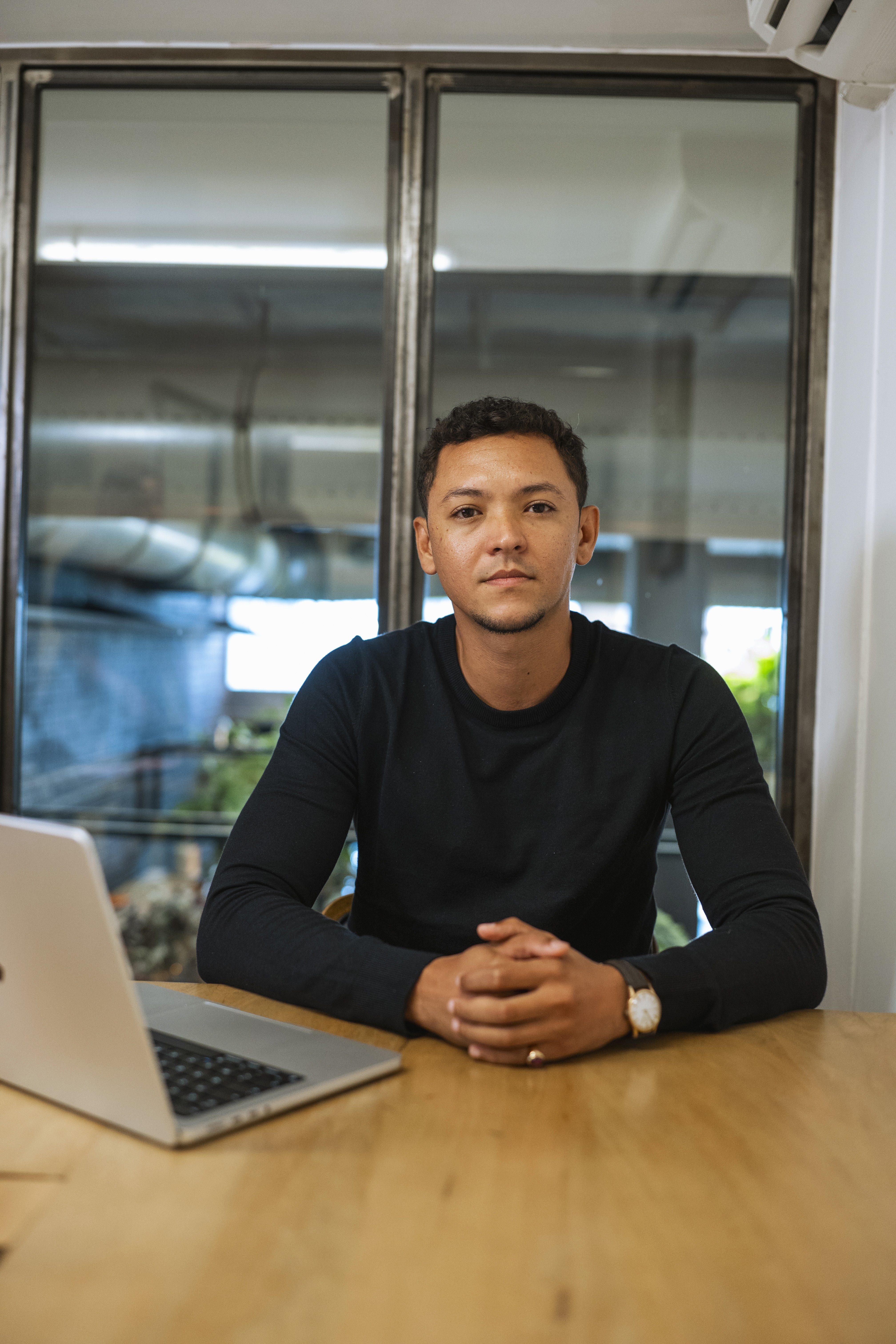 Profile portrait of a man in a white shirt against a light background