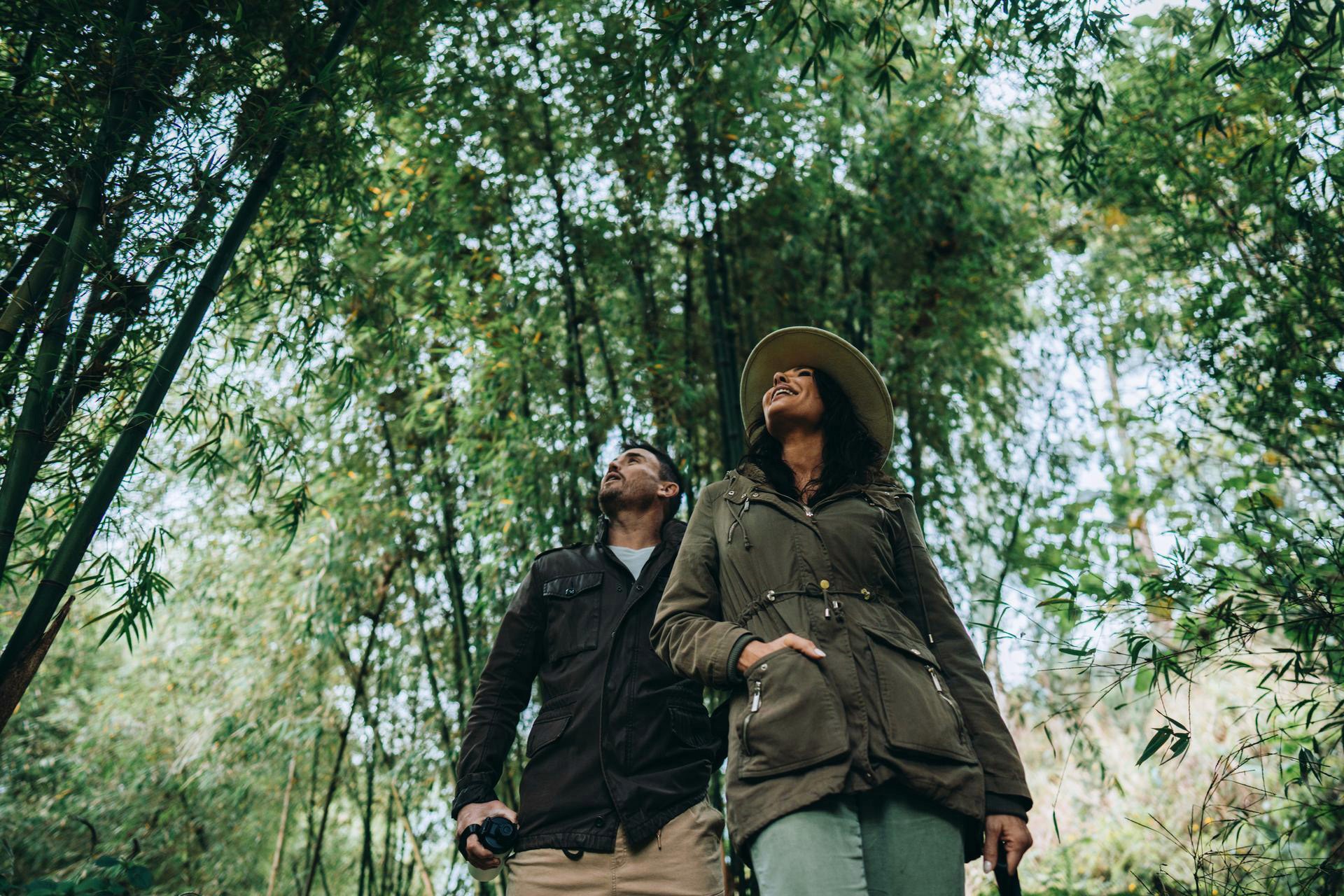A couple geared up in layered jackets and sturdy boots - dressed just right for a day of gorilla trekking through Uganda's bamboo forests.