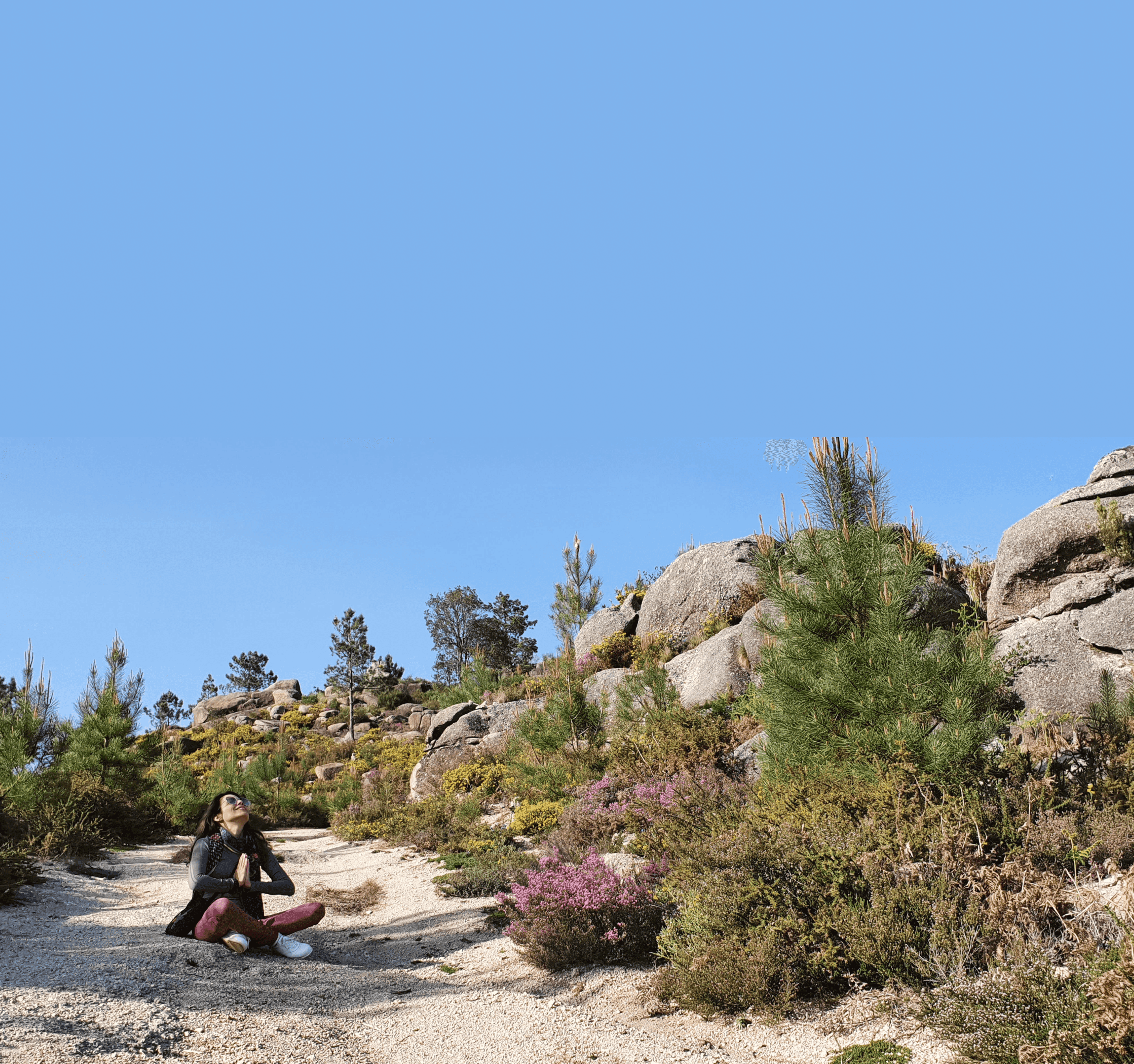 Samira sitting in lotus pose looking at the sky