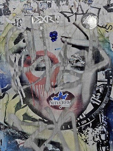 Photograph of a graffitied wall layered with spray paint, torn posters, and a partially obscured face. The overlapping marks and vivid colors merge into an expressive, chaotic portrait that captures the tension between creation and erasure.