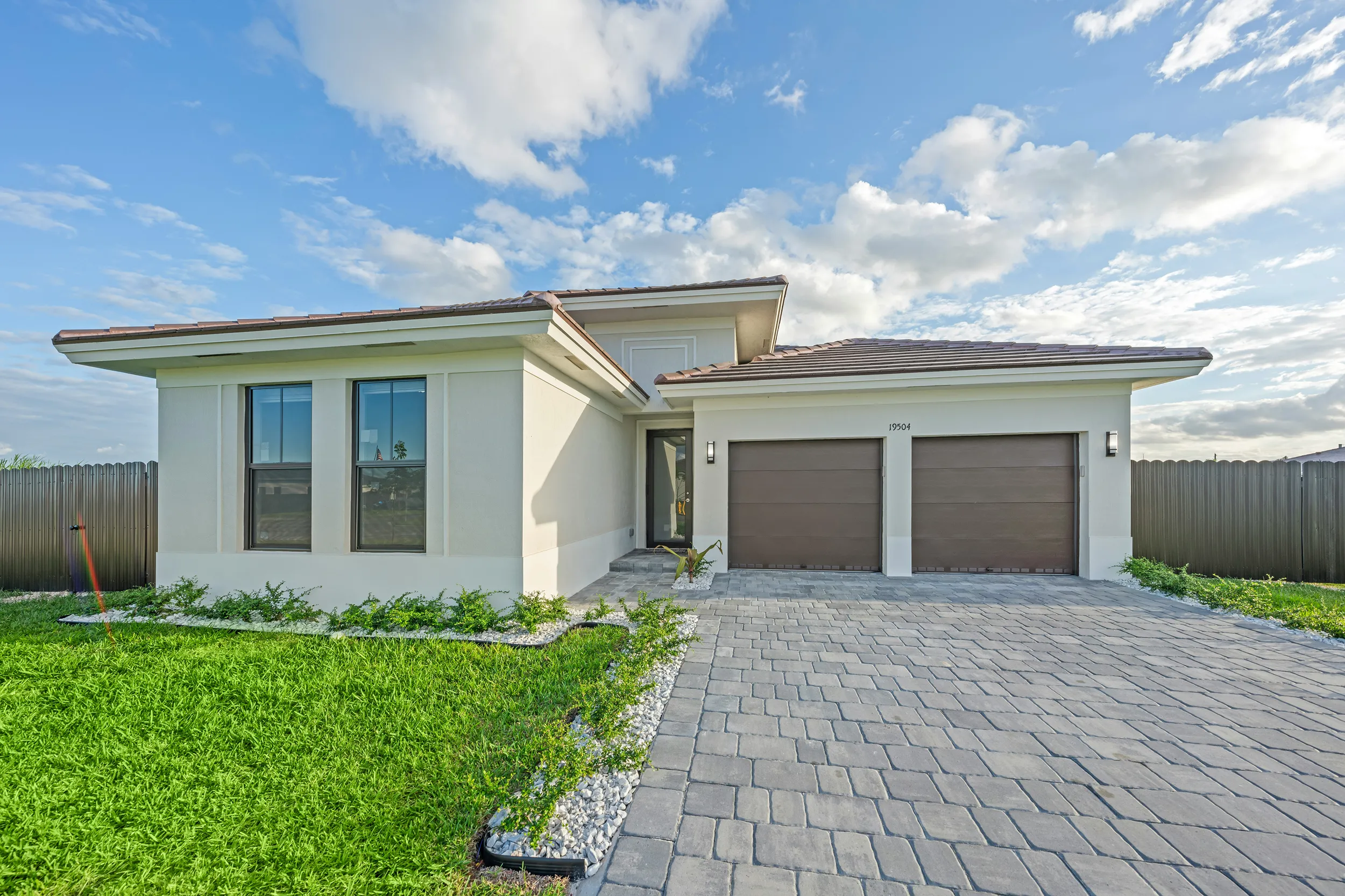 Modern single-story house with double garage and paved driveway