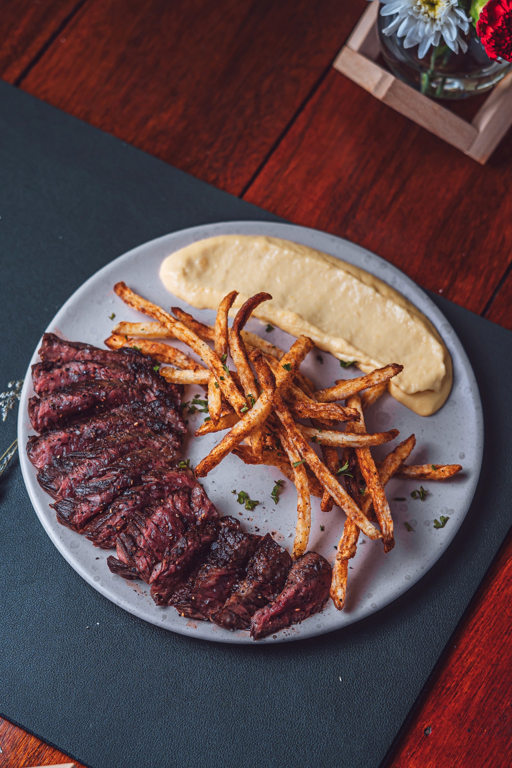 A beautifully arranged table with various dishes, including fruits, bread, and wine, set for a meal.