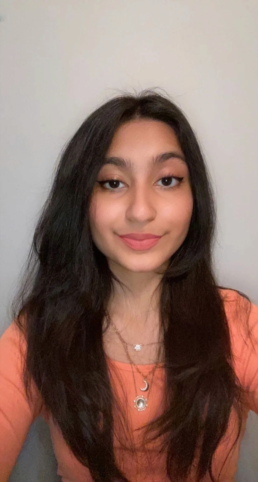 young lady (intern) smiling and folding arms