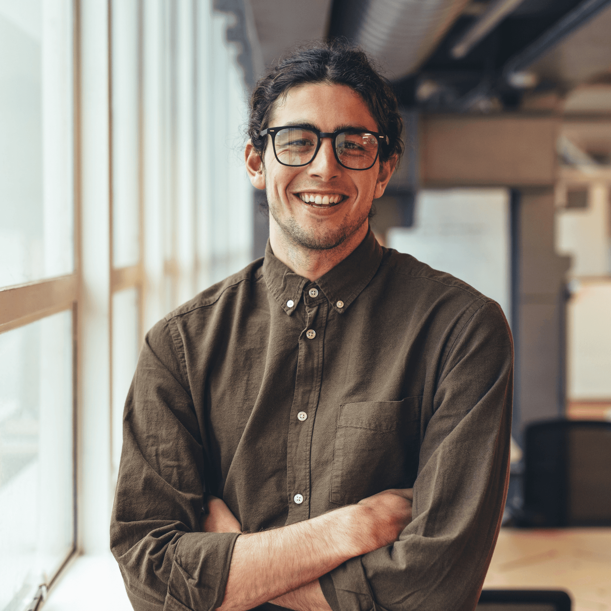 A person with dreadlocks and round glasses looks confidently at the camera. Neon blue and purple lighting creates a modern, artistic vibe.