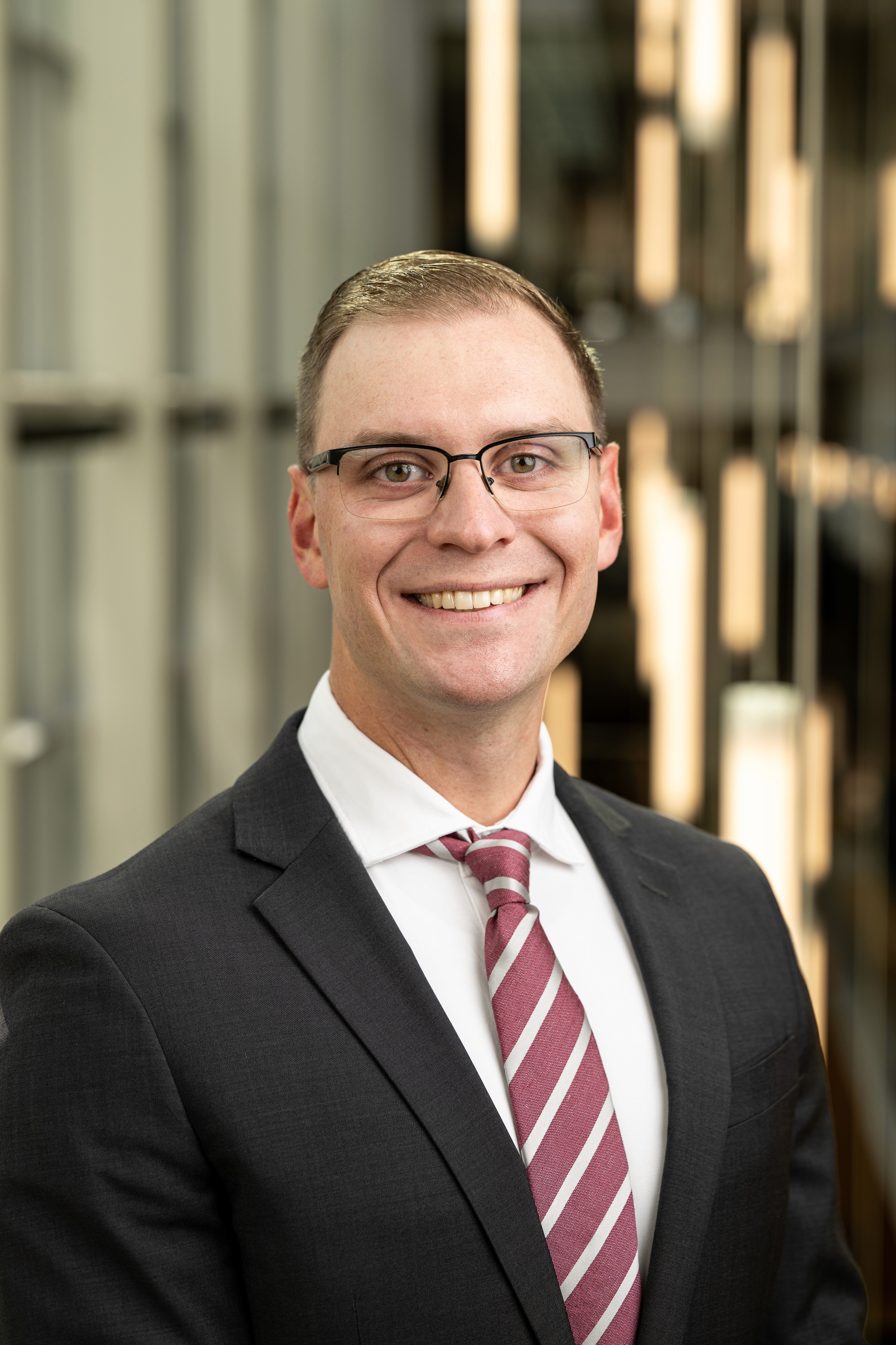 Man in suit and tie poses for headshot