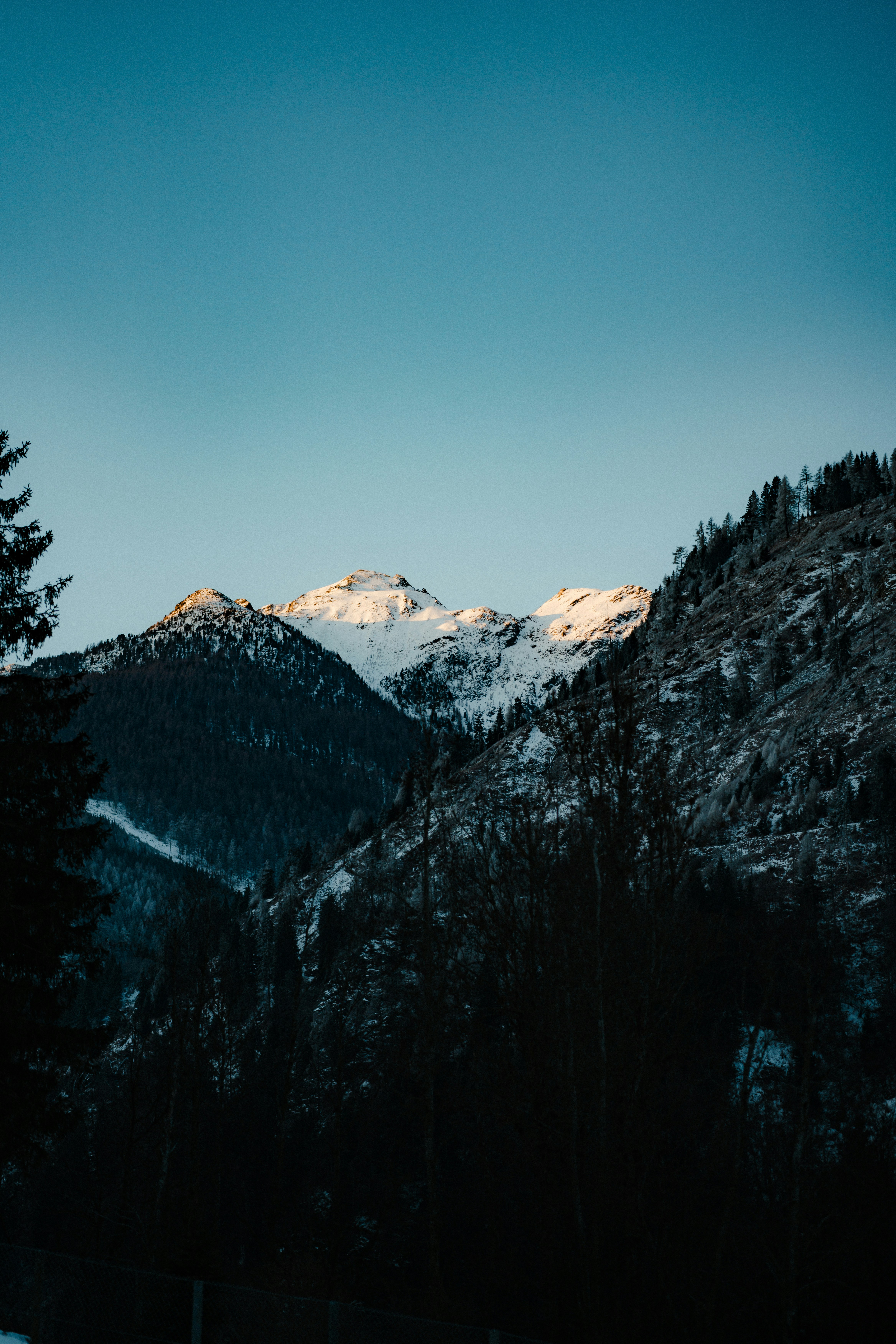 Snow-capped mountains under a clear blue sky