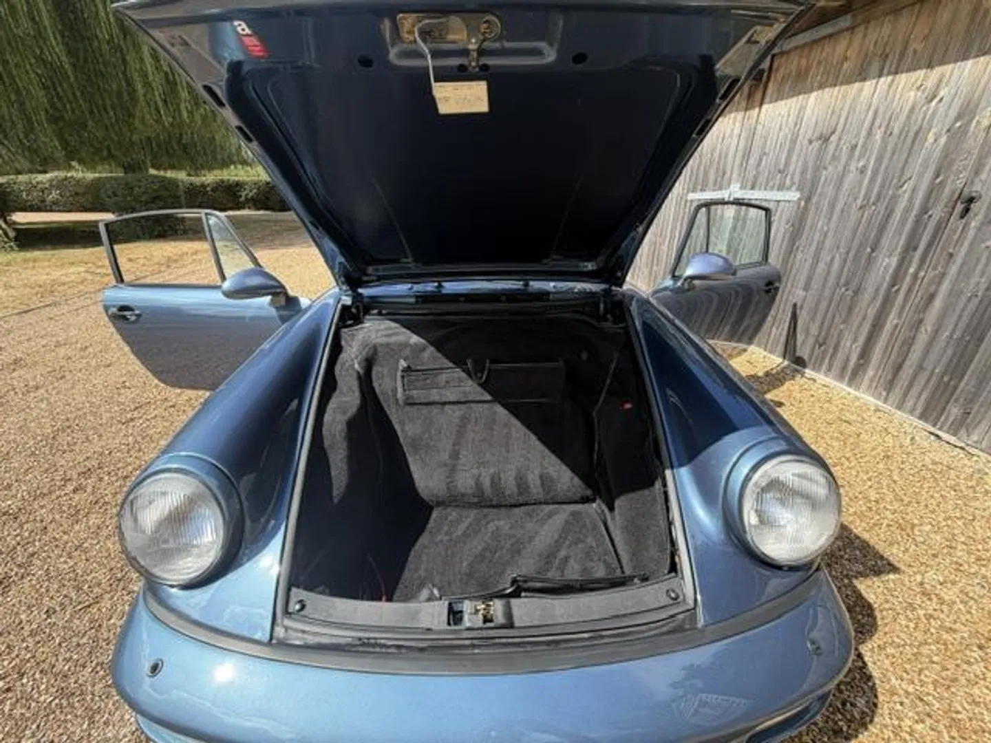 Open front luggage compartment with carpeted boot and headlights