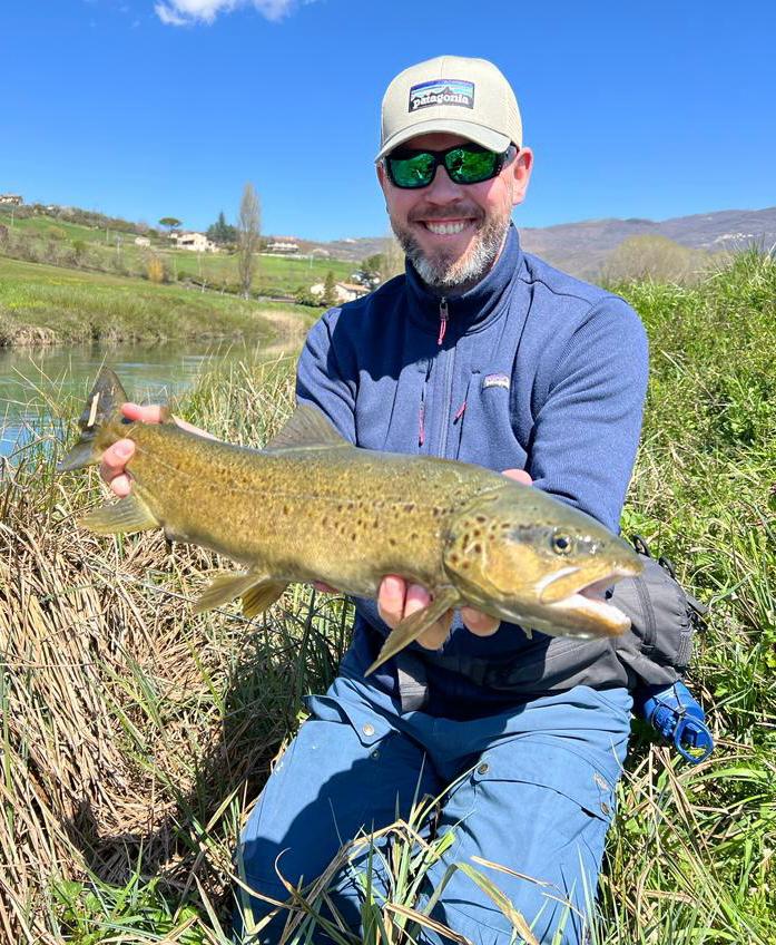 Guide sight fishing for trout on a spring creek in the Rieti valley