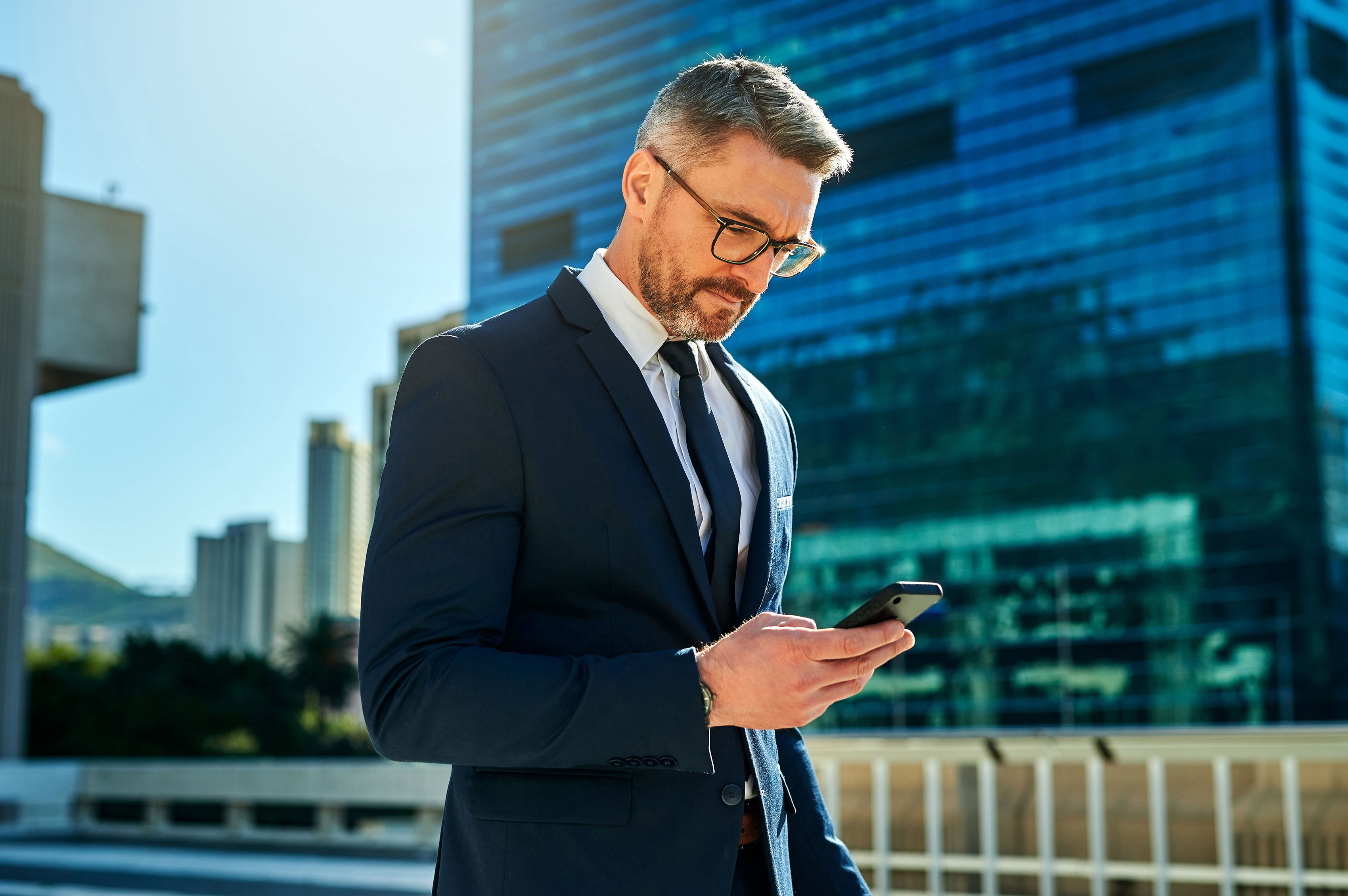 man using phone in city