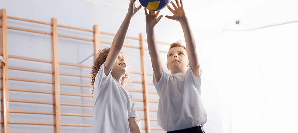 Elementary students playing volleyball during a HOKALI after-school sports program